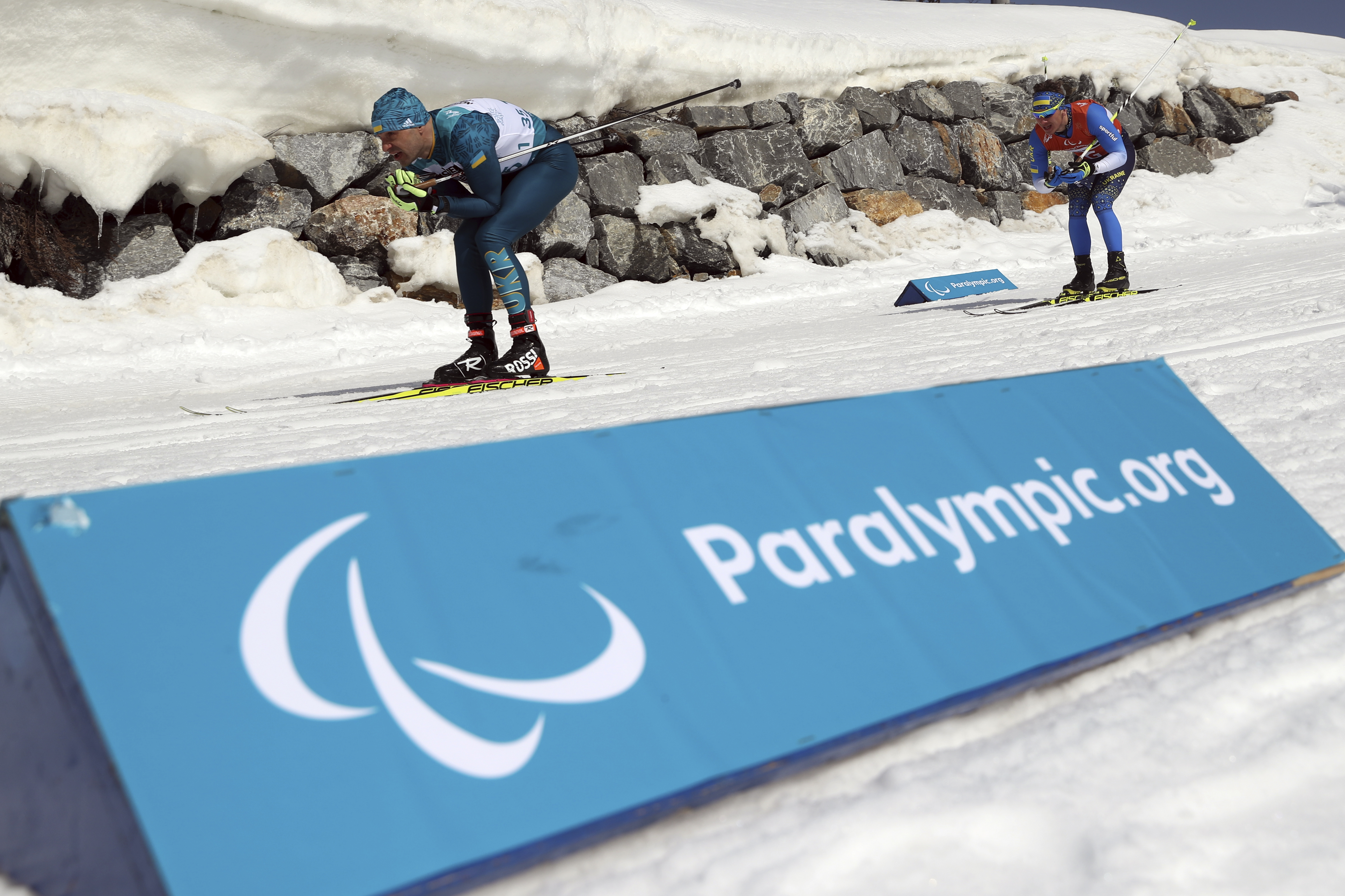 Vitaliy Luk'yanenko skis ahead of his guide Ivan Marchyshak as they compete in the Biathlon Visually Impaired Men's 7.5km at the Alpensia Biathlon Centre during the 2018 Winter Paralympics in Pyeongchang, South Korea, Saturday, March 10, 2018. (AP Photo/Ng Han Guan)