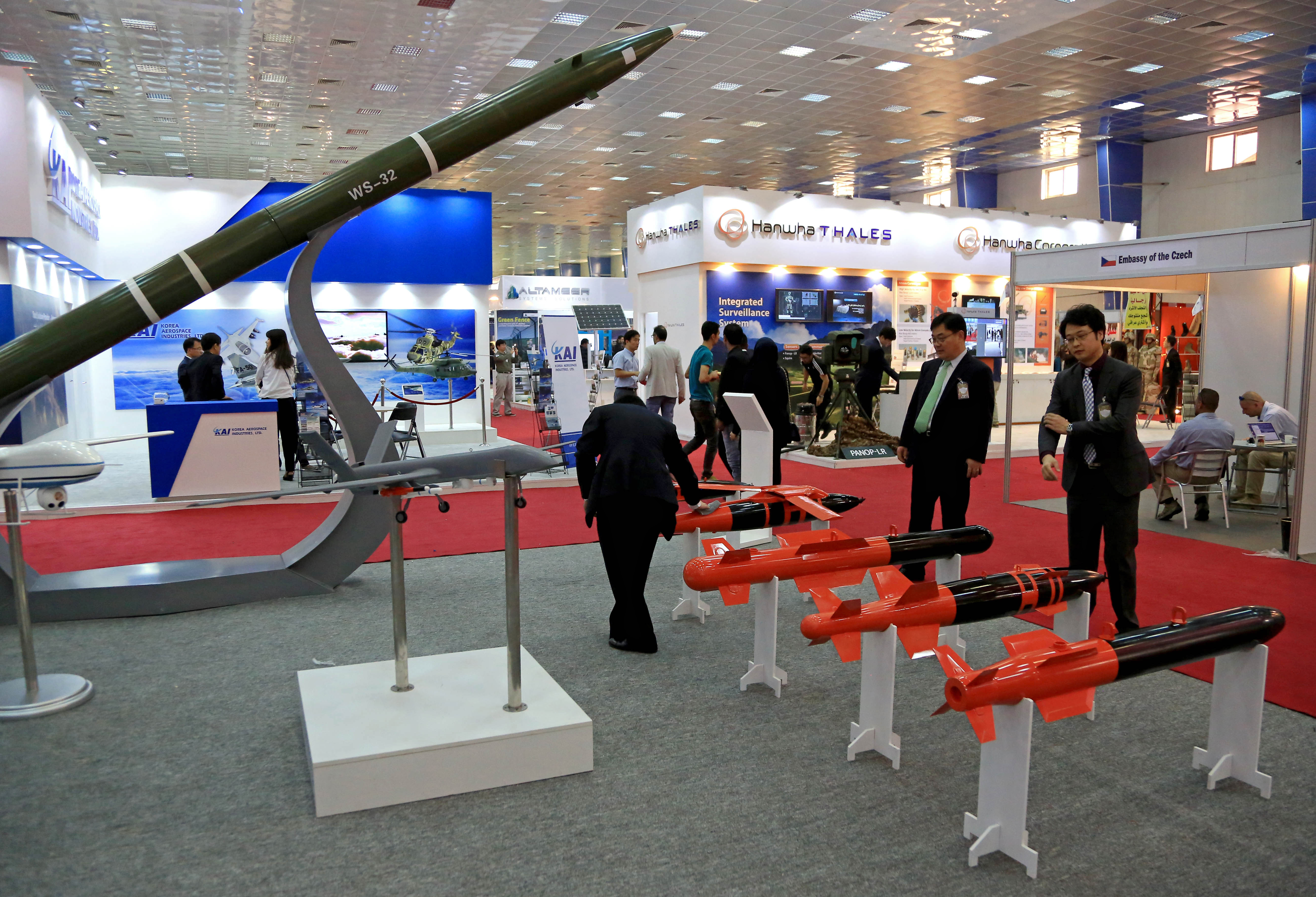 Visitors attend the fourth annual weapons exhibition organized by the Iraqi defense ministry, at the Baghdad International Fairgrounds, Saturday, March, 5, 2016. International companies from Japan, Iran, Germany, Egypt, China and others displayed weapons, armored vehicles, as well as sample models of aircraft, vehicles and boats. (AP Photo/Karim Kadim)