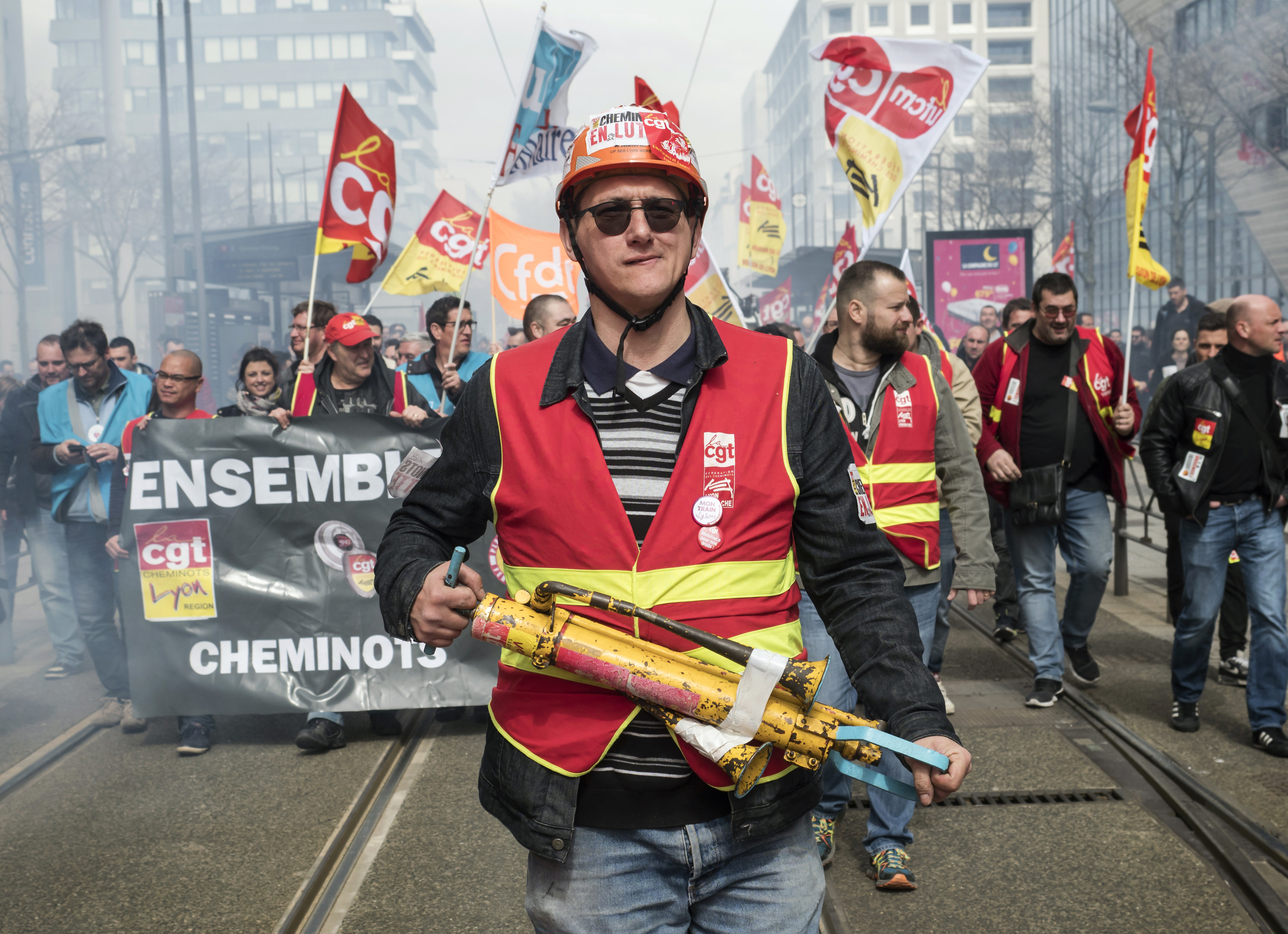 French rail workers demonstrate in Lyon, central France, Tuesday, April 3, 2018. French unions plan strikes two days every week through June to protest government plans to eliminate some rail worker benefits — part of broader European plans to open national railways to competition. (AP Photo/Laurent Cipriani)