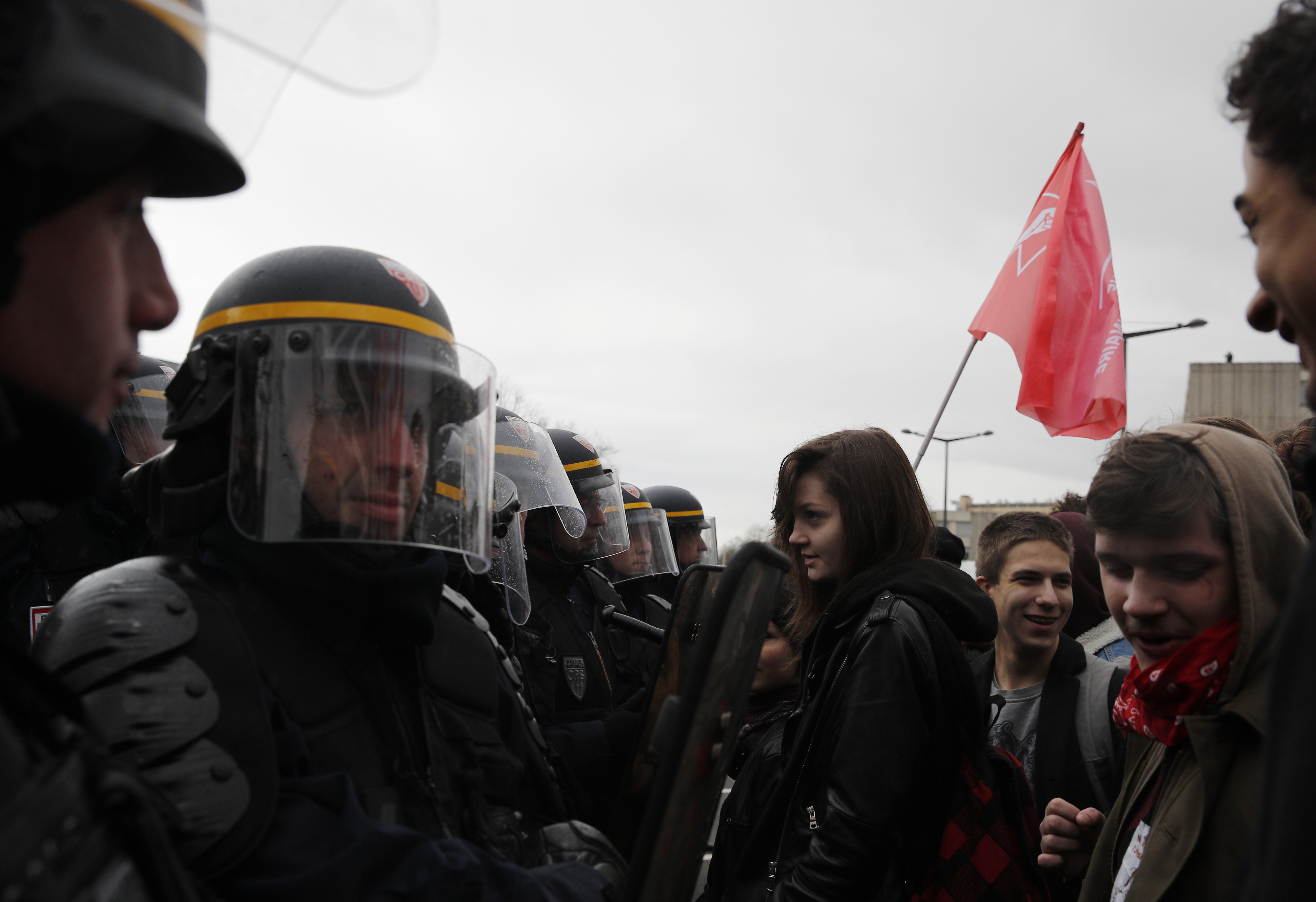 Students face riot police officer as they demonstrate outside the Rouen hospital, Normandy, Thursday, April 5, 2018 ahead of French President Emmanuel Macron's visit. Macron is unveiling a long-awaited autism plan, to help parents struggling to provide children on the autism spectrum with basic education and care. (AP Photo/Christophe Ena, Pool)