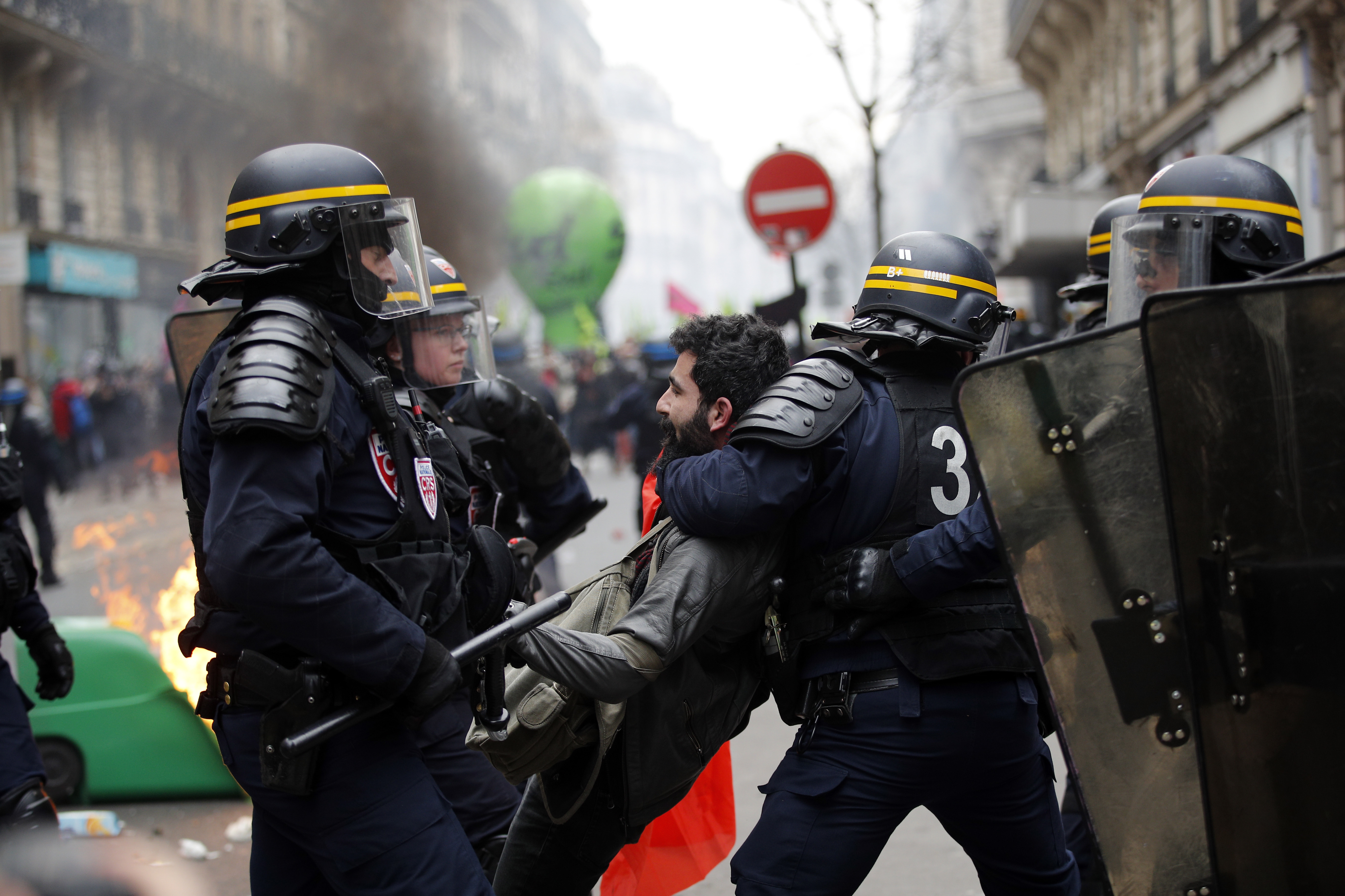 French riot police detain a protestor during a rail workers demonstration in Paris, Tuesday, April 3, 2018. French unions plan strikes two days every week through June to protest government plans to eliminate some rail worker benefits — part of broader European plans to open national railways to competition. (AP Photo/Christophe Ena)