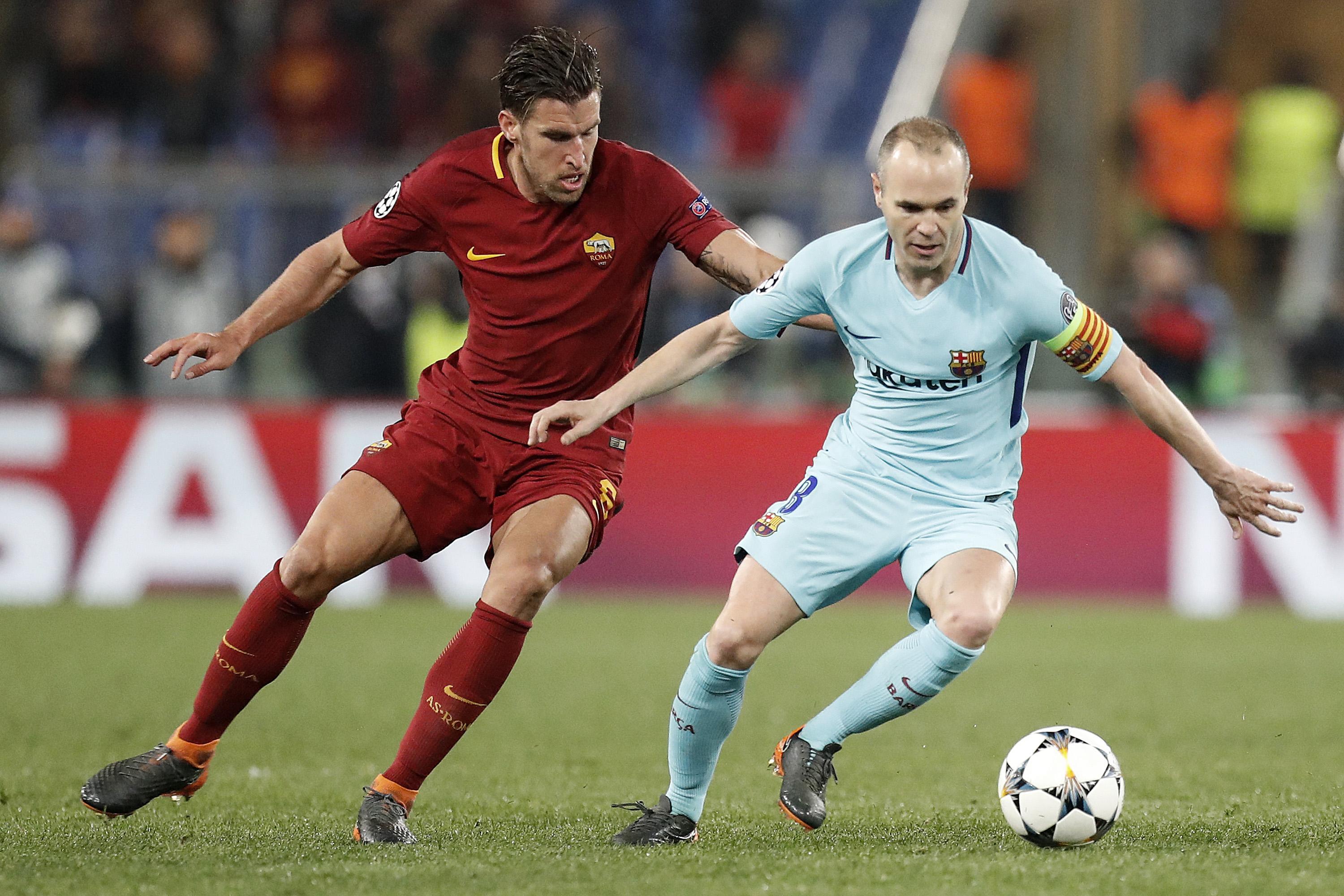 Roma's Kevin Strootman (L) and Barcelona's Andres Iniesta in action during Champions League quarter-final second leg soccer match between AS Roma and FC Barcelona at the Olimpico Stadium, Rome, Italy, 10 April 2018. ANSA/RICCARDO ANTIMIANI