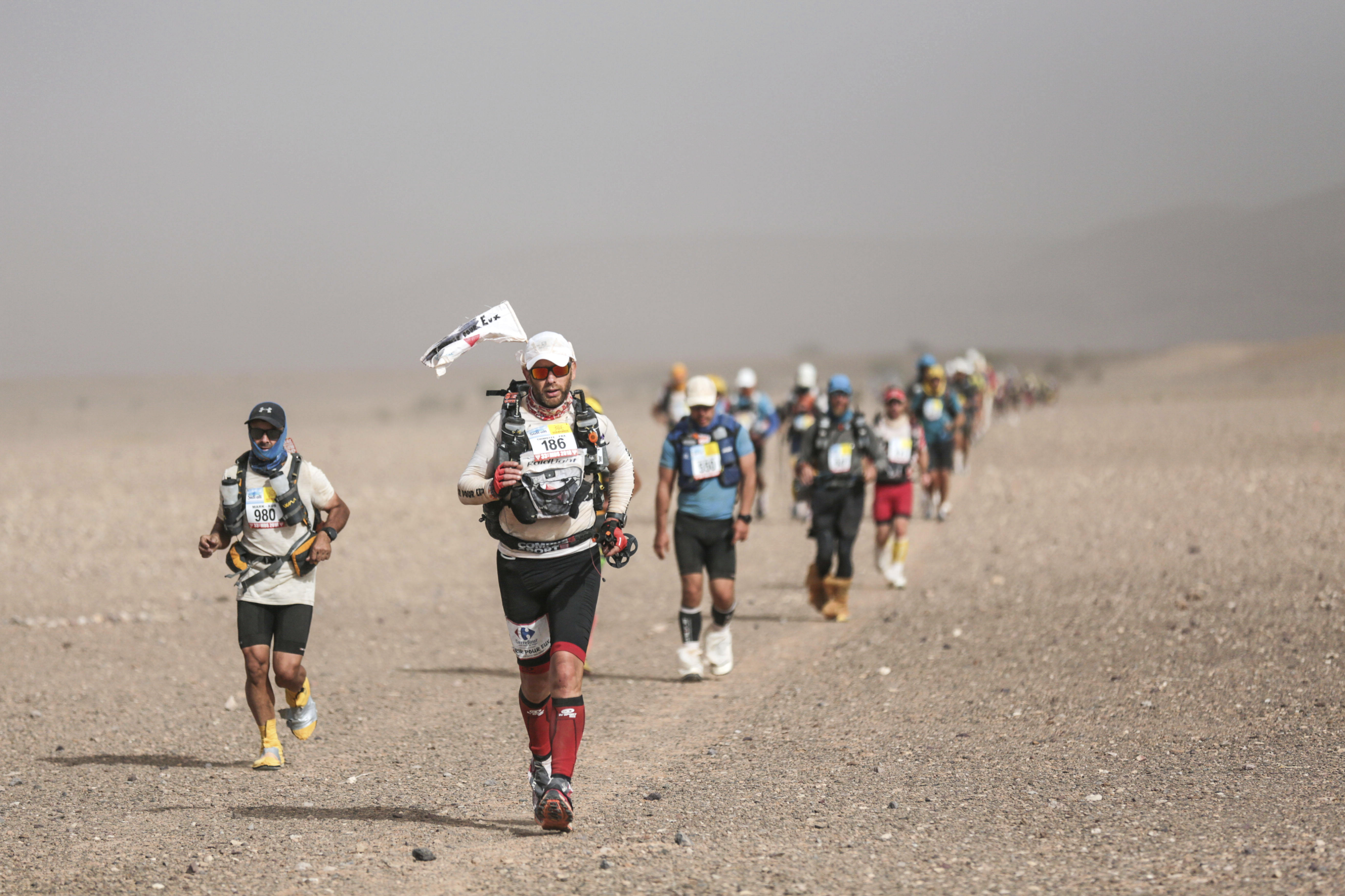Competitors take part in stage 5 of the 33rd edition of Marathon des Sables, in the Sahara desert, near Merzouga, southern Morocco, Friday, April 13, 2018. The marathon, held every year in Morocco, is a 250-km ultra-trail that takes part over 6 stages in extremely grueling conditions. (AP Photo/Mosa'ab Elshamy)