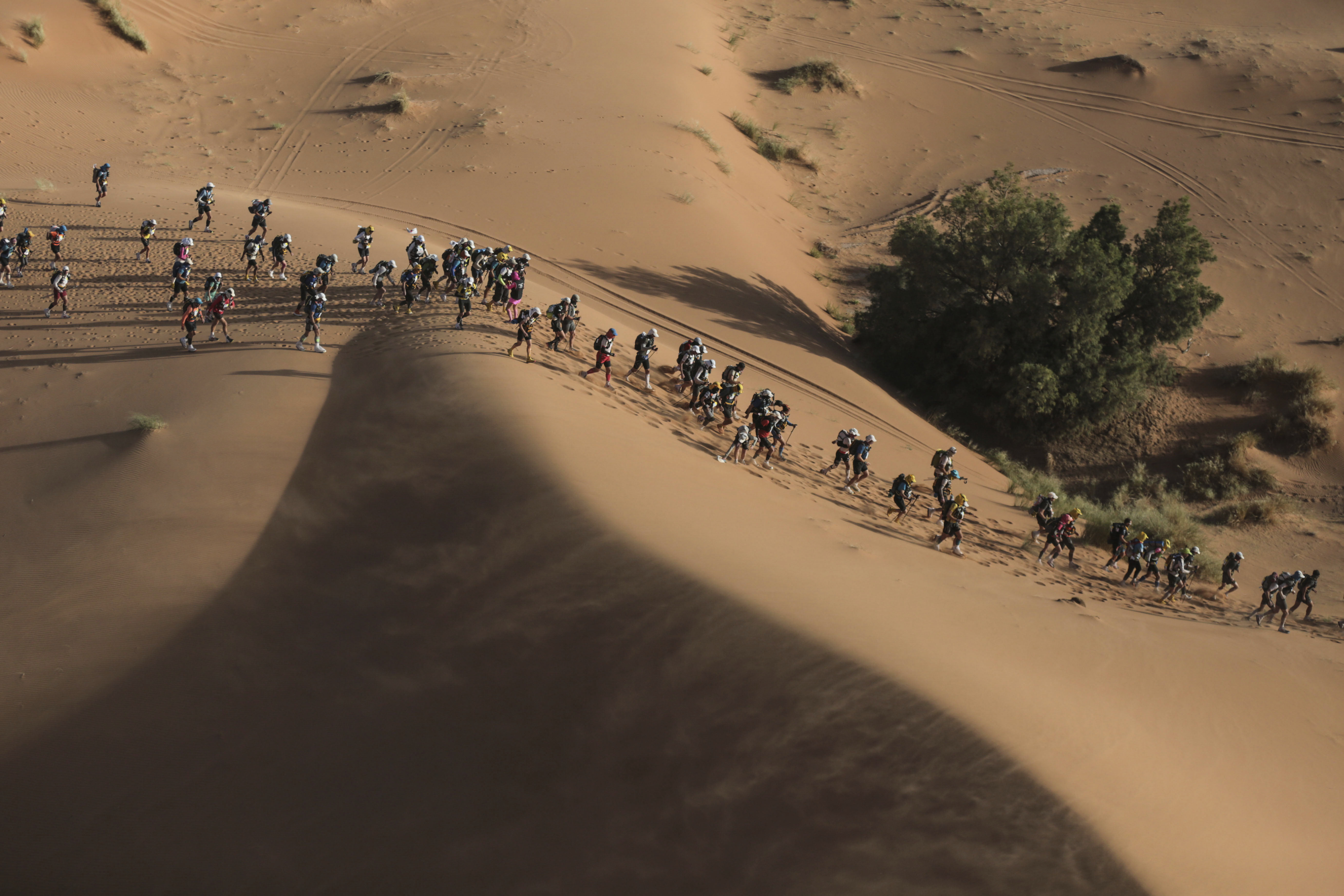 Competitors take part in stage 5 of the 33rd edition of Marathon des Sables, in the Sahara desert, near Merzouga, southern Morocco, Friday, April 13, 2018. The marathon, held every year in Morocco, is a 250-km ultra-trail that takes part over 6 stages in extremely grueling conditions. (AP Photo/Mosa'ab Elshamy)