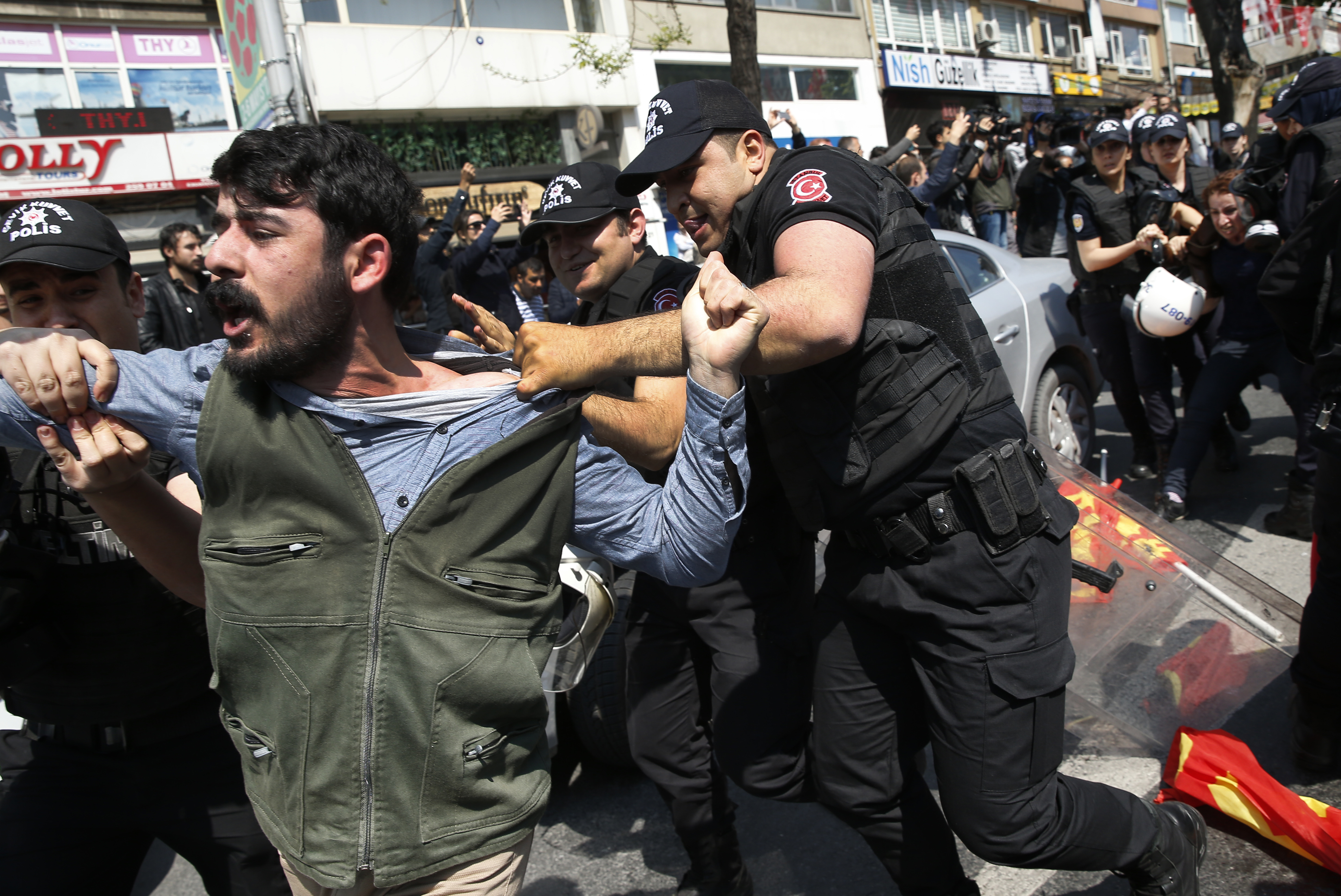 Police scuffle with demonstrators during May Day protests in Istanbul, Turkey, Tuesday, May 1, 2018. Police in Istanbul detained dozens of demonstrators who tried to march toward Istanbul's symbolic Taksim Square in defiance of a ban by the government, citing security concerns. (AP Photo/Lefteris Pitarakis)