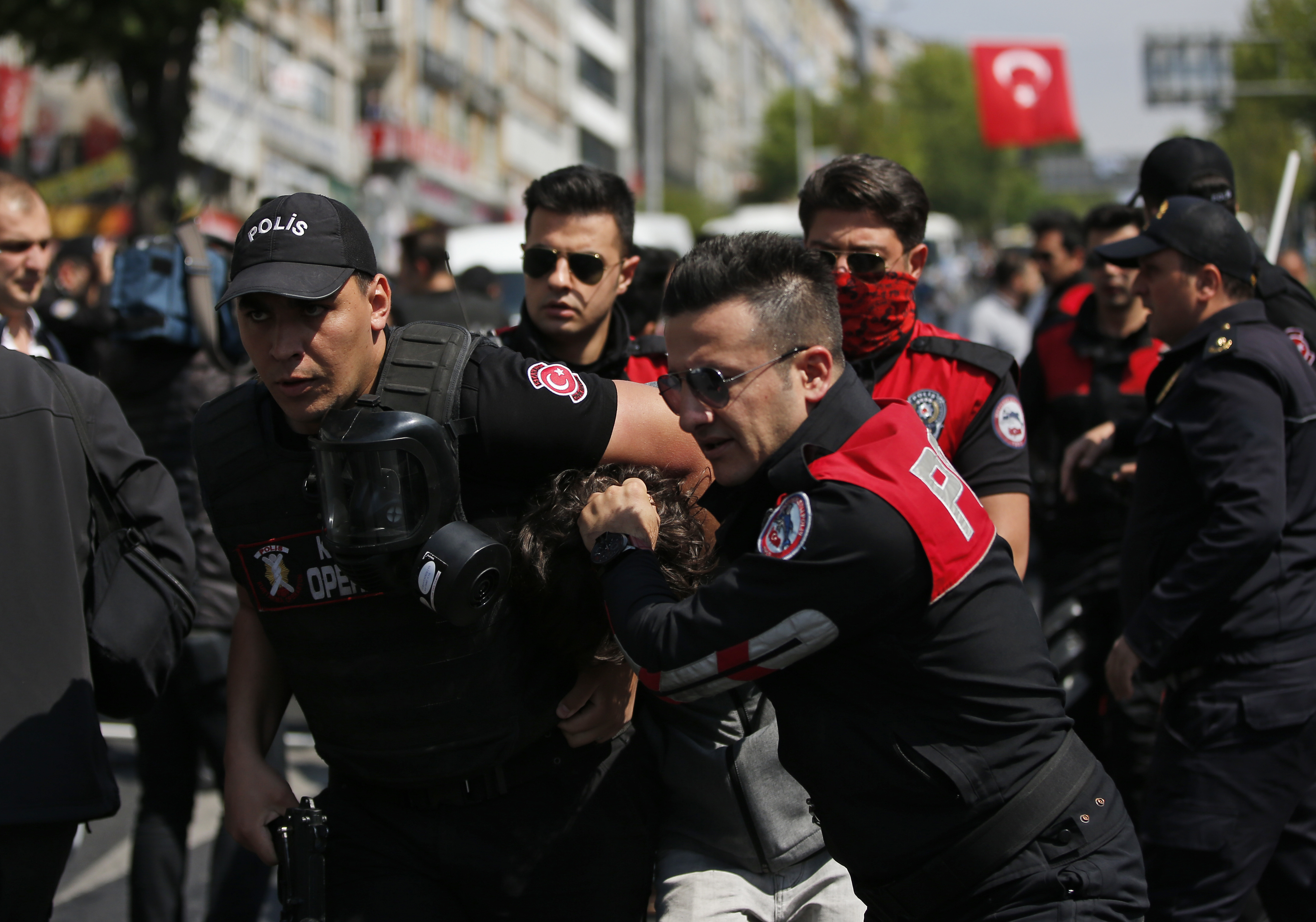 Turkish police officers arrest a demonstrator during May Day protests in Istanbul, Tuesday, May 1, 2018. Police in Istanbul detained dozens of demonstrators who tried to march toward Istanbul's symbolic Taksim Square in defiance of a ban by the government, citing security concerns. (AP Photo/Lefteris Pitarakis)