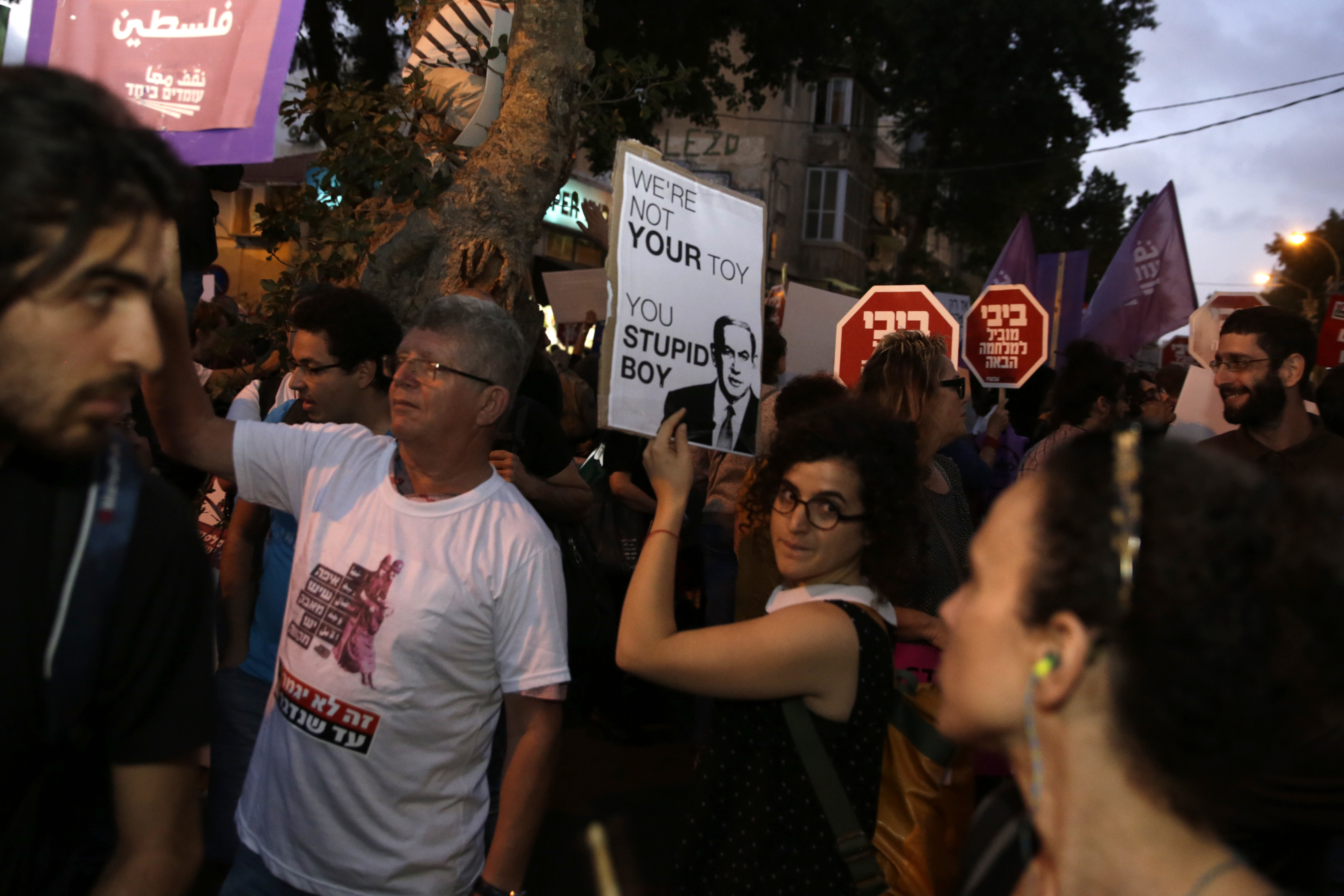Left wing Israelis hold signs during a demonstration against the situation in Gaza in Tel Aviv, Tuesday, May 15, 2018. Israel faced a growing backlash Tuesday and new charges of using excessive force, a day after Israeli troops firing from across a border fence killed 59 Palestinians and wounded more than 2,700 at a mass protest in Gaza. (AP Photo/Sebastian Scheiner)