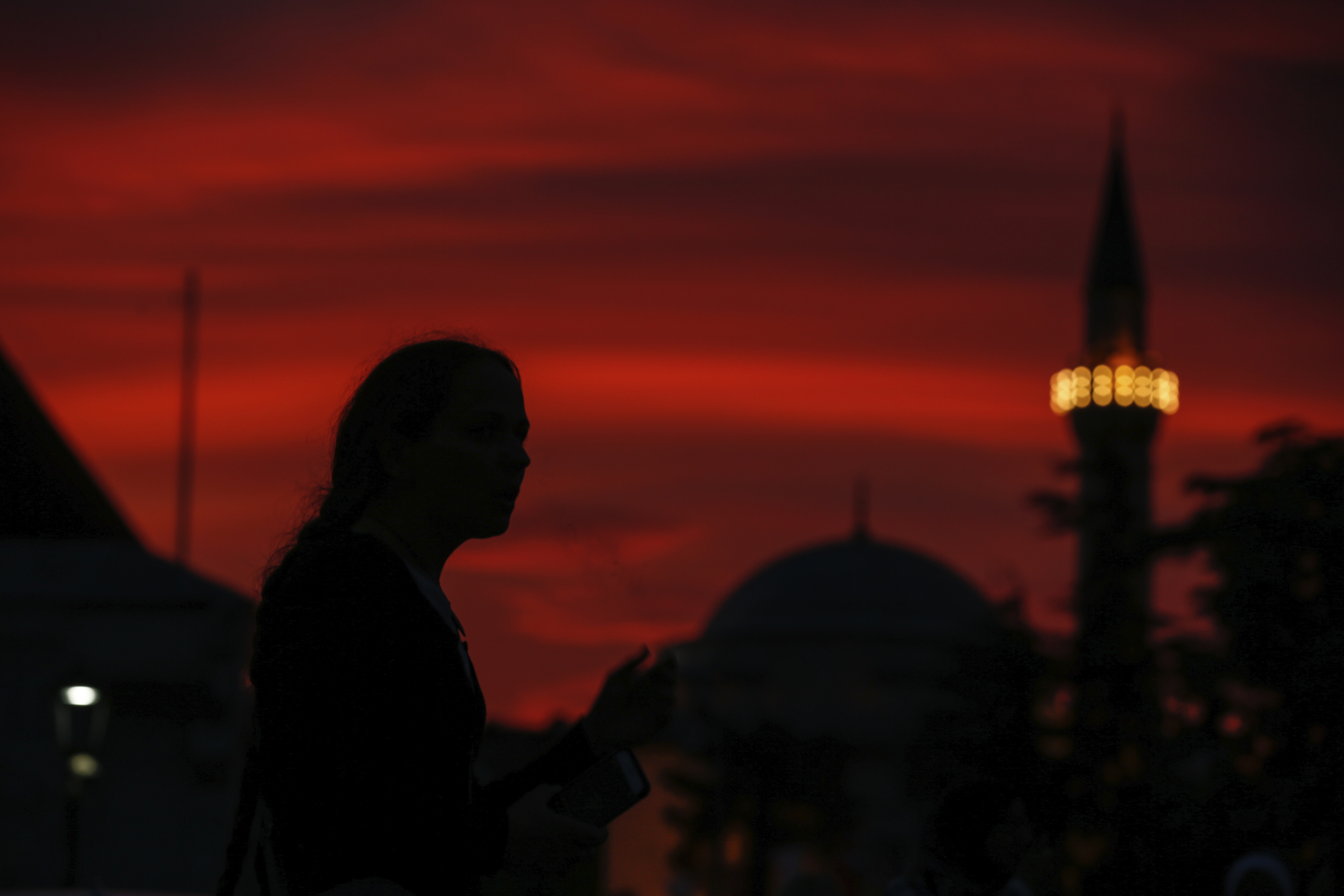 People walk in the historic Sultanahmet district of Istanbul, Wednesday, May 16, 2018 on the first day of the fasting month of Ramadan. Muslims throughout the world are marking Ramadan - a month of fasting during which the observants abstain from food, drink and other pleasures from sunrise to sunset. After an obligatory sunset prayer, a large feast known as 'iftar' is shared with family and friends. (AP Photo/Emrah Gurel)