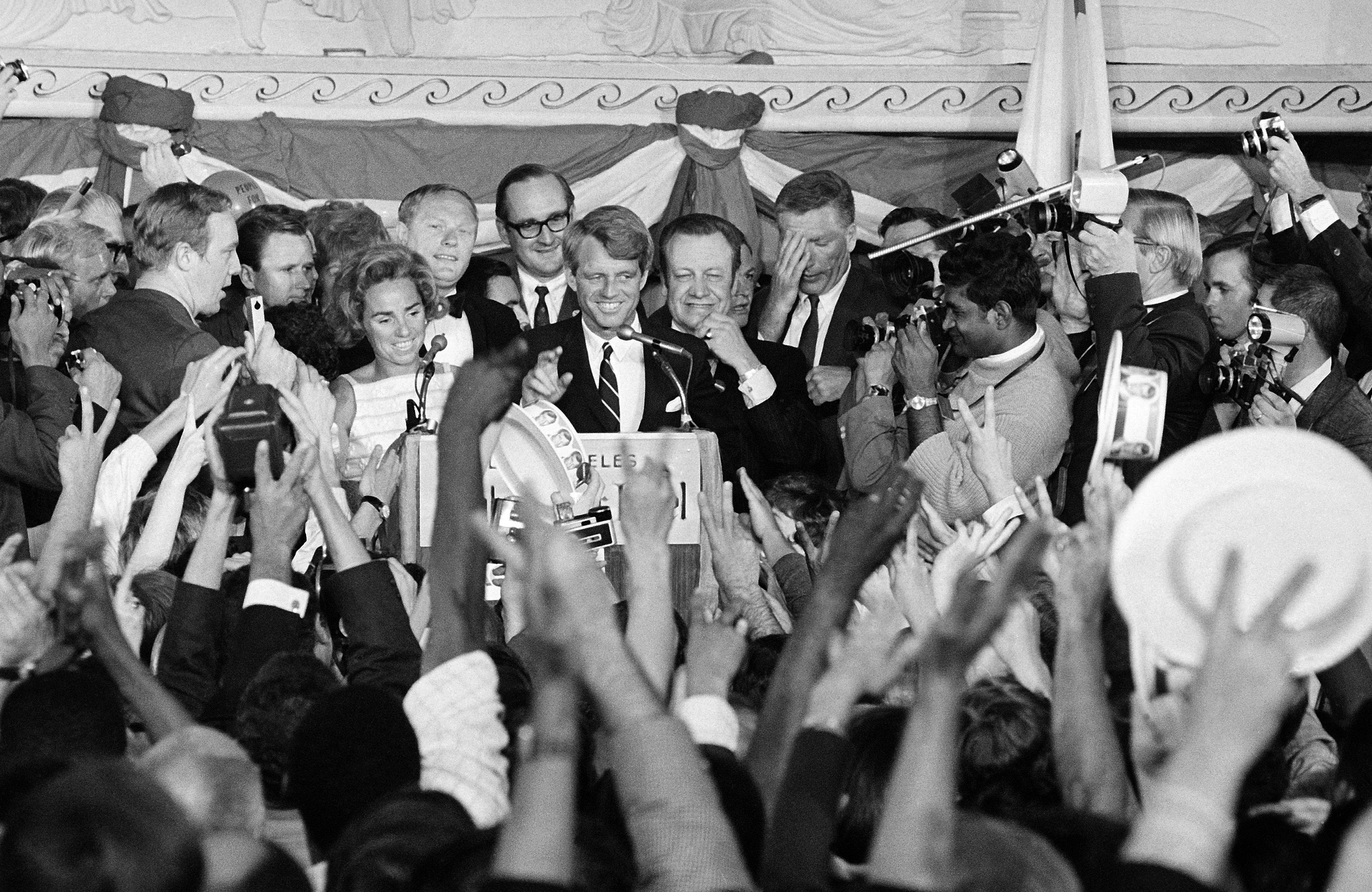 Sen. Robert Kennedy, center, stands with Ethel, left, and Speaker Jesse Unruh of the California Assembly, right, at the Ambassador Hotel in Los Angeles on June 5, 1968. the crowd gathered at the Kennedy headquarters before the shooting. (AP Photo)