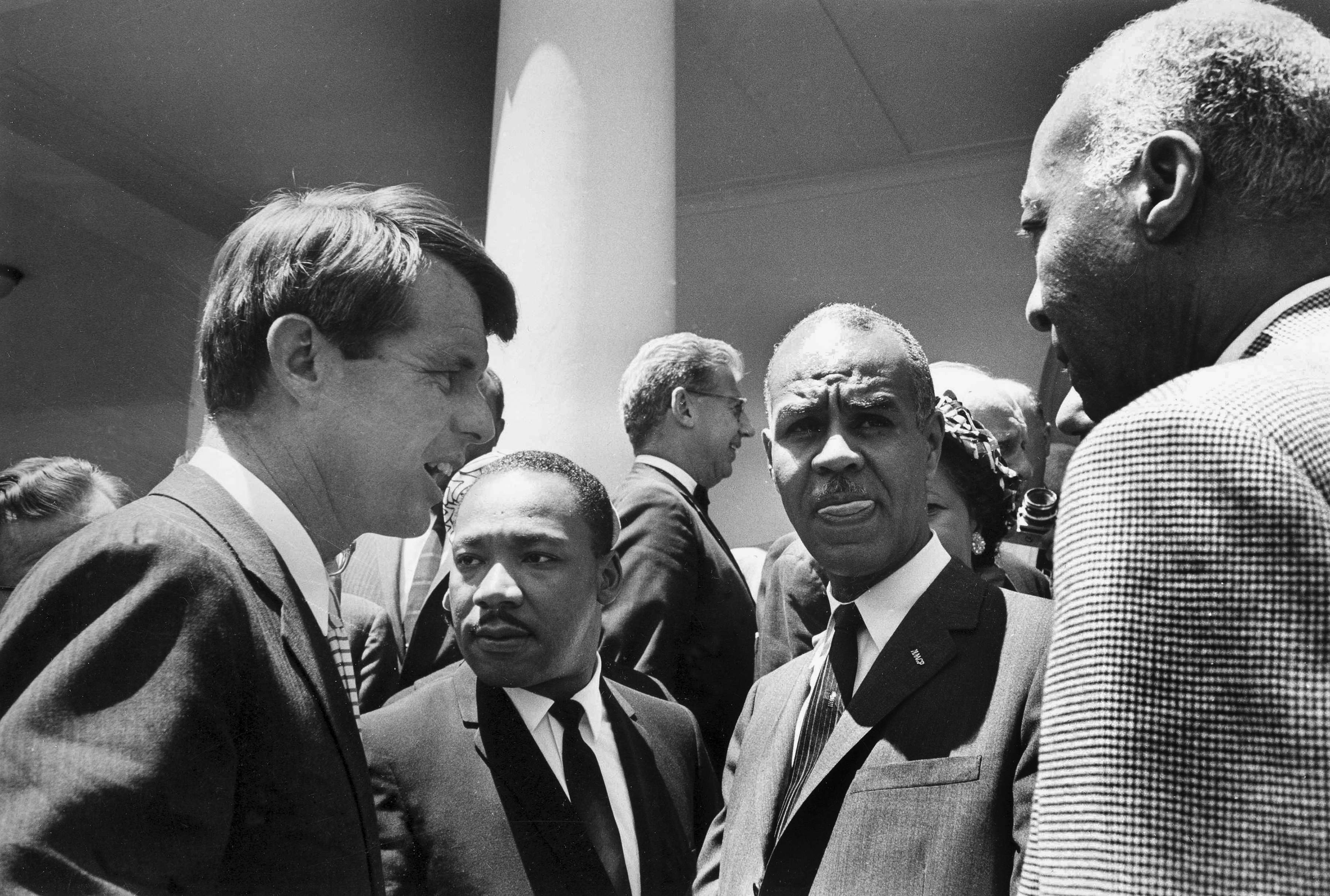 FILE - In this June 22, 1963, file photo, U.S. Attorney General Robert F. Kennedy, left, speaks with civil rights leaders, beginning second from left, Rev. Martin Luther King, Jr., head of the Southern Christian Leadership Conference; Roy Wilkins, executive secretary of the NAACP; and A. Phillip Randolph, president of Brotherhood of Sleeping Car Porters, on the White House grounds, in Washington, DC. Civil rights lawyer Joseph Rauh stands in the background at center. Nearly 50 years after Robert F. Kennedy's assassination, a new documentary series on his life and transformation into a liberal hero is coming to Netflix. 