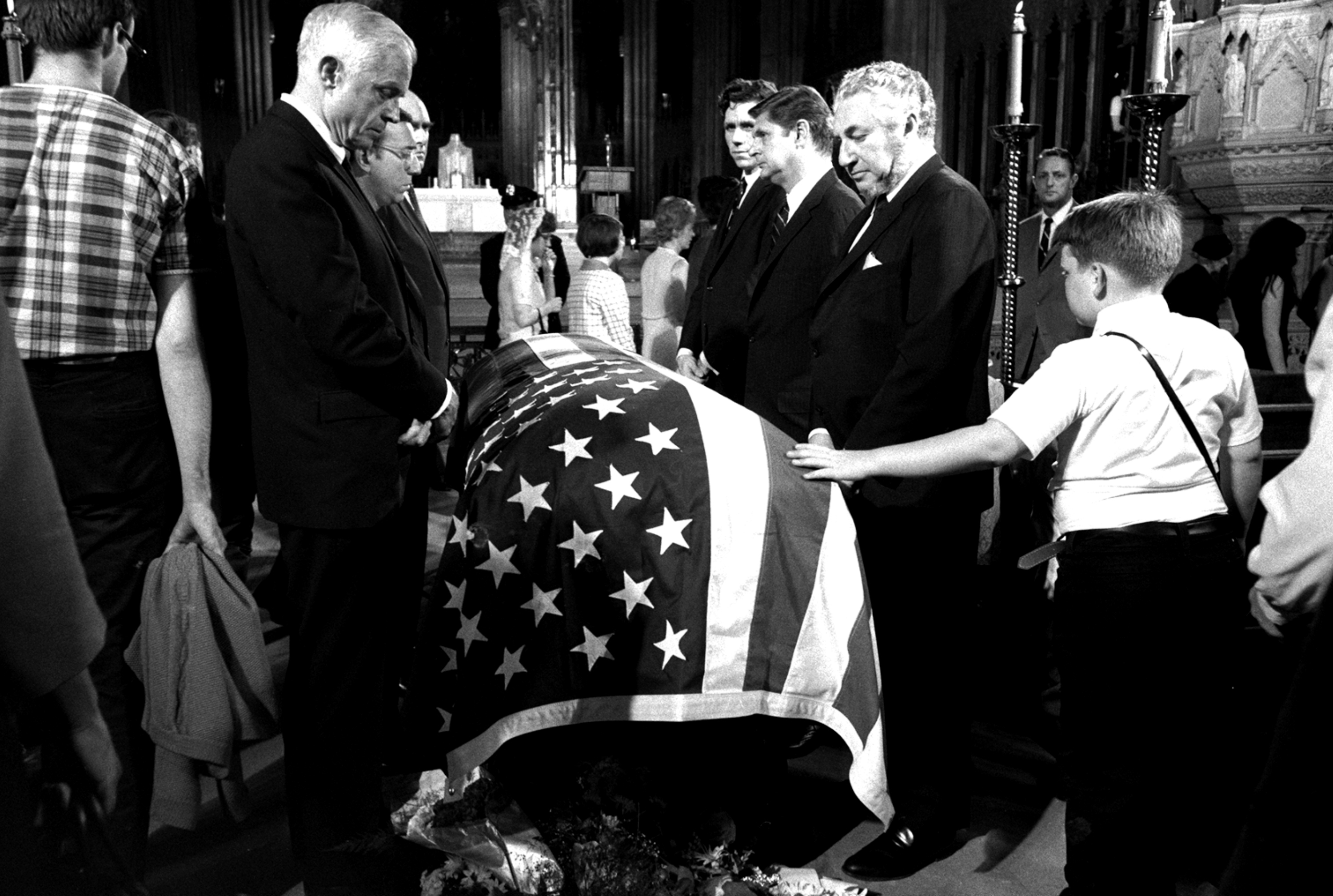 FILE-- In this June 7, 1968 file photograph, a young boy touches the casket of Senator Robert F. Kennedy, D-NY, while paying respects at New York's St. Patrick's Cathedral. The suburban Boston house where Robert F. Kennedy was born, now a national historic site in tribute to his more famous brother, President John F. Kennedy, is holding a special exhibition to mark the 50th anniversary of RFK's assassination on June 6, 1968. (AP Photo/stf)