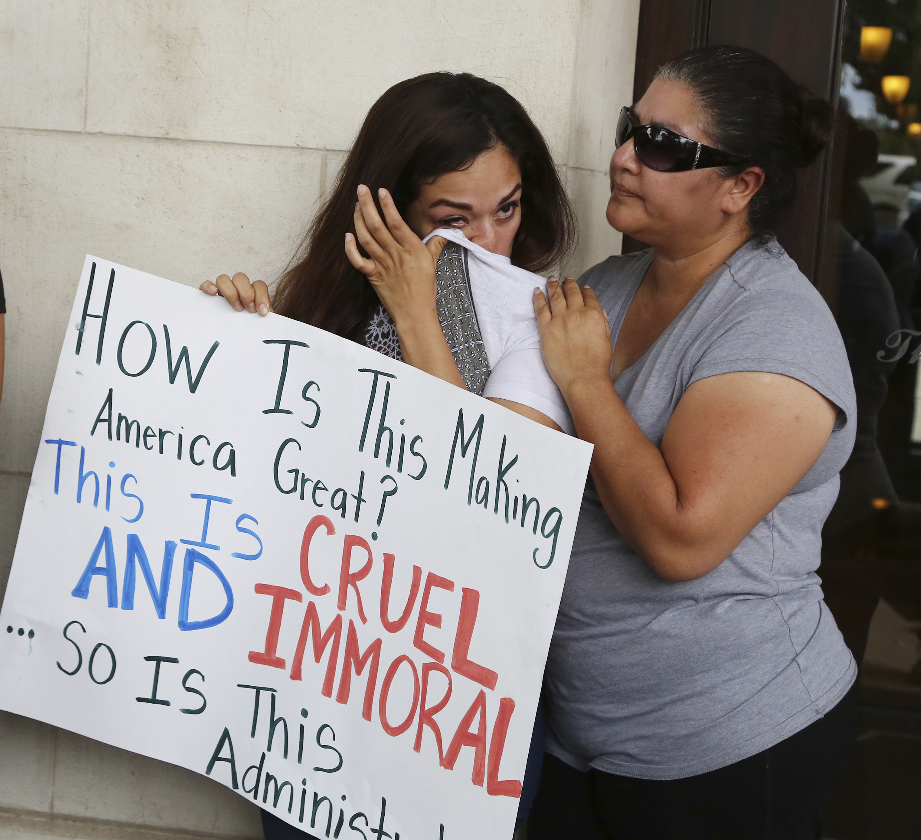 Adriana Sanchez, left, wipes a tear from her face as she is comforted by her mother, Rosalina De La Rosa, following a protest to end forced separation of children from their parents at the border in downtown Waco, Texas, Tuesday, June 19, 2018. (Rod Aydelotte/Waco Tribune-Herald via AP)