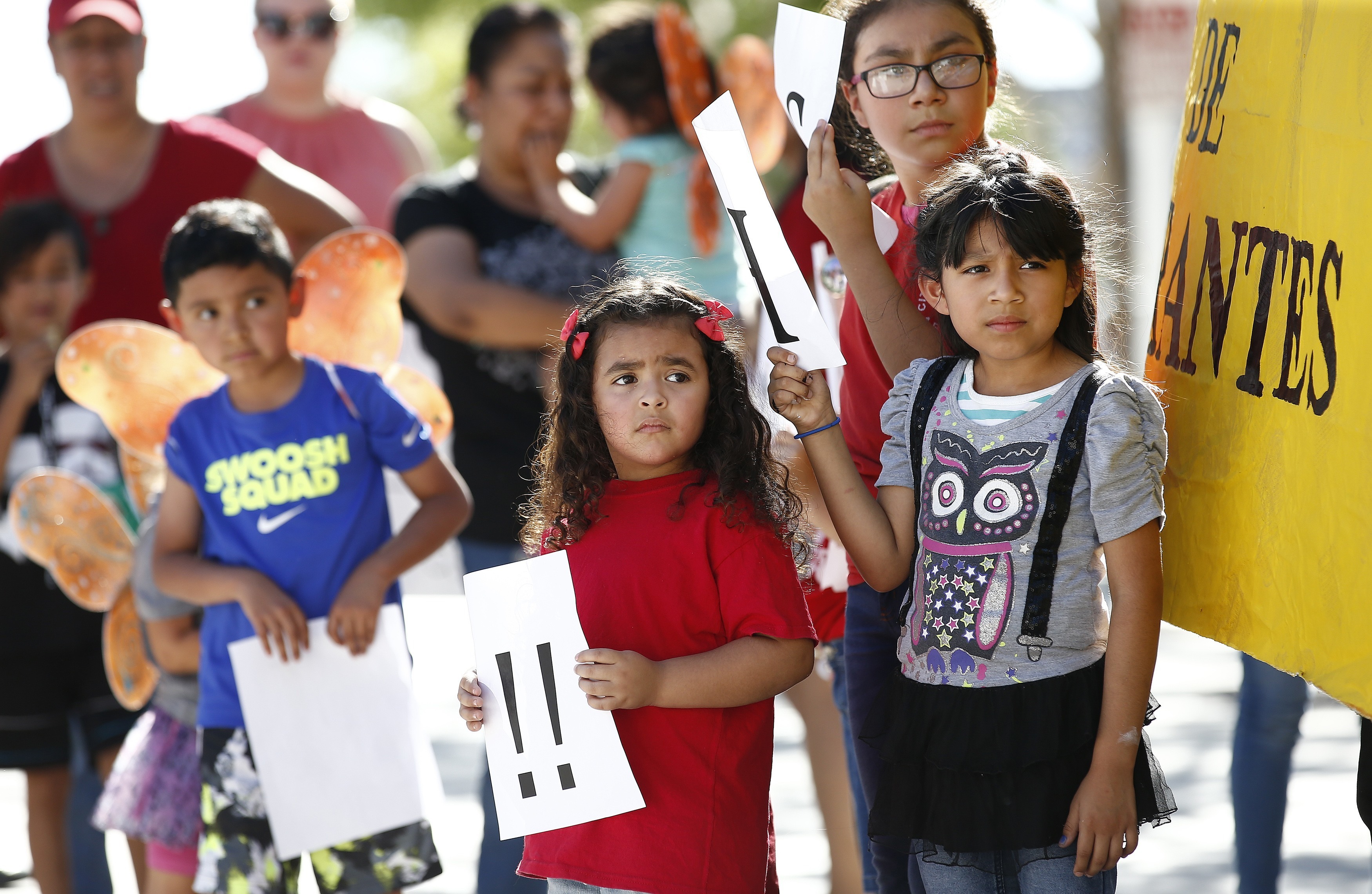 Children listen to speakers during an immigration family separation protest in front of the Sandra Day O'Connor U.S. District Court building, Monday, June 18, 2018, in Phoenix. An unapologetic President Donald Trump defended his administration's border-protection policies Monday in the face of rising national outrage over the forced separation of migrant children from their parents. (AP Photo/Ross D. Franklin)