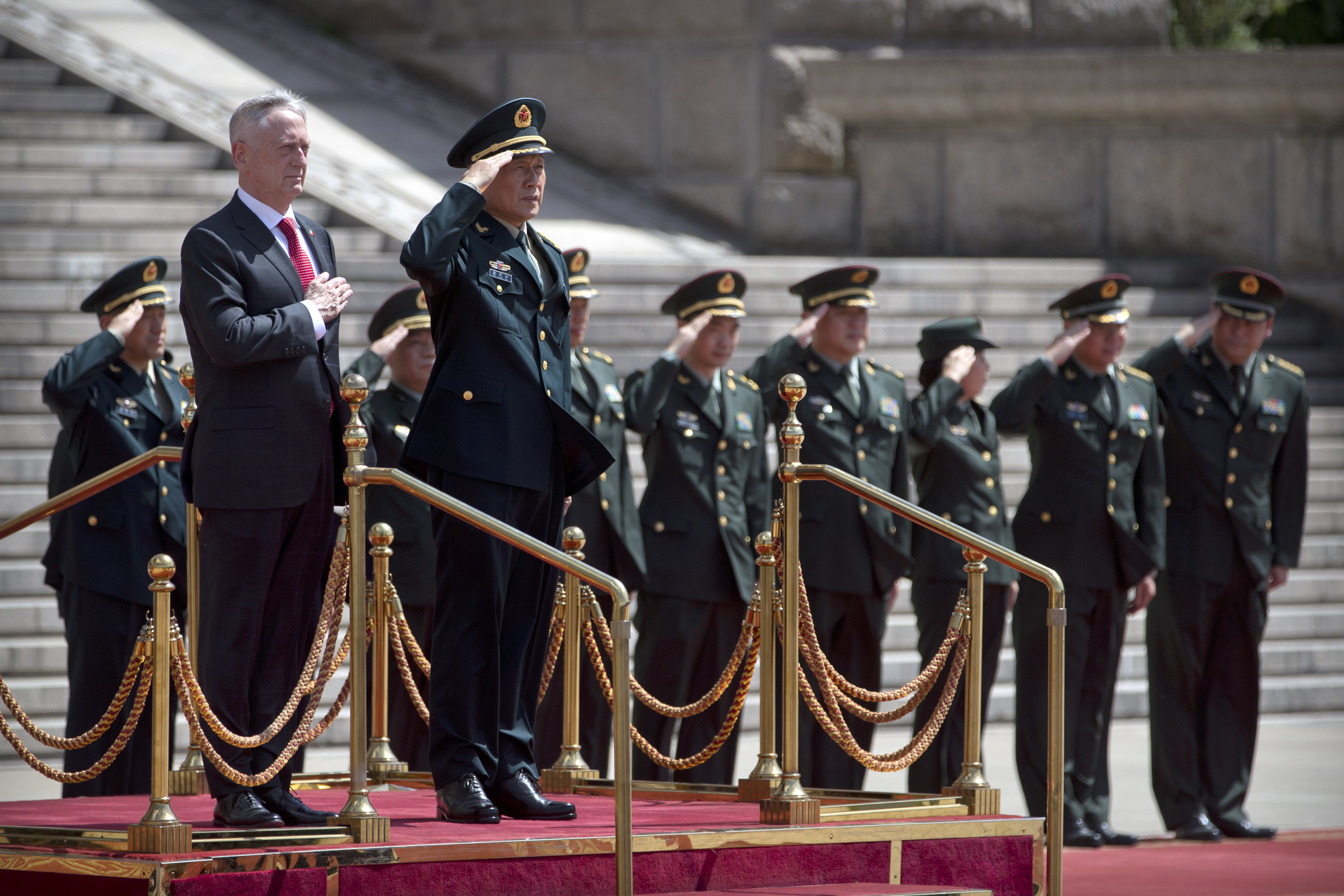 U.S. Defense Secretary Jim Mattis, front left, and China's Defense Minister Wei Fenghe stand as the American national anthem is played during a welcome ceremony at the Bayi Building in Beijing, Wednesday, June 27, 2018. (AP Photo/Mark Schiefelbein, Pool)