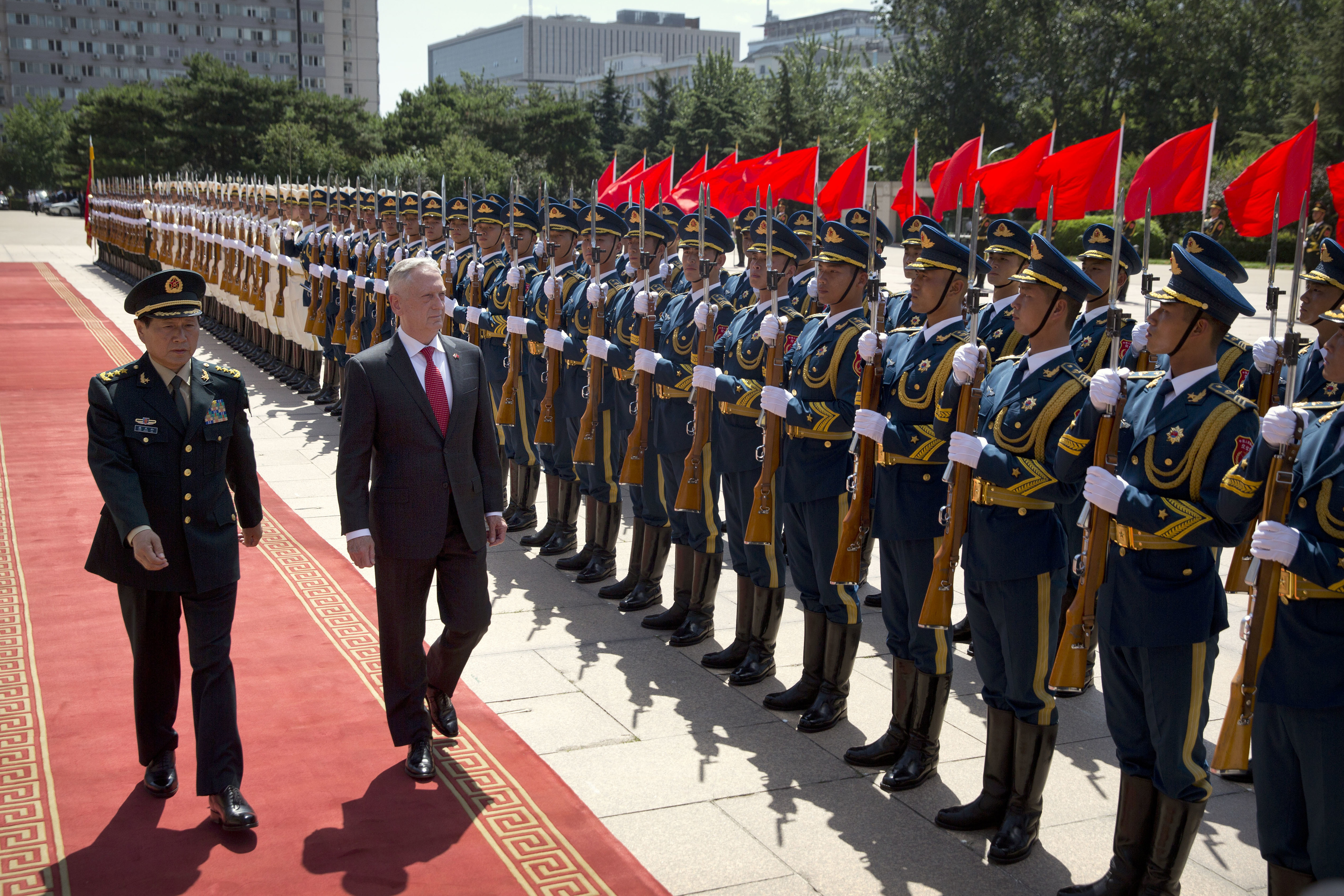 China's Defense Minister Wei Fenghe, left, and U.S. Defense Secretary Jim Mattis review an honor guard during a welcome ceremony at the Bayi Building in Beijing, Wednesday, June 27, 2018. (AP Photo/Mark Schiefelbein, Pool)