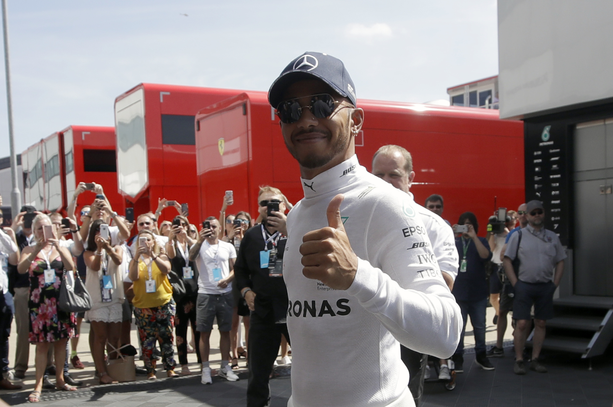 Mercedes driver Lewis Hamilton of Britain walks in the paddock before the third free practice at the Silverstone racetrack, Silverstone, England, Saturday, July 7, 2018. The British Formula One Grand Prix will be held on Sunday. (AP Photo/Luca Bruno)