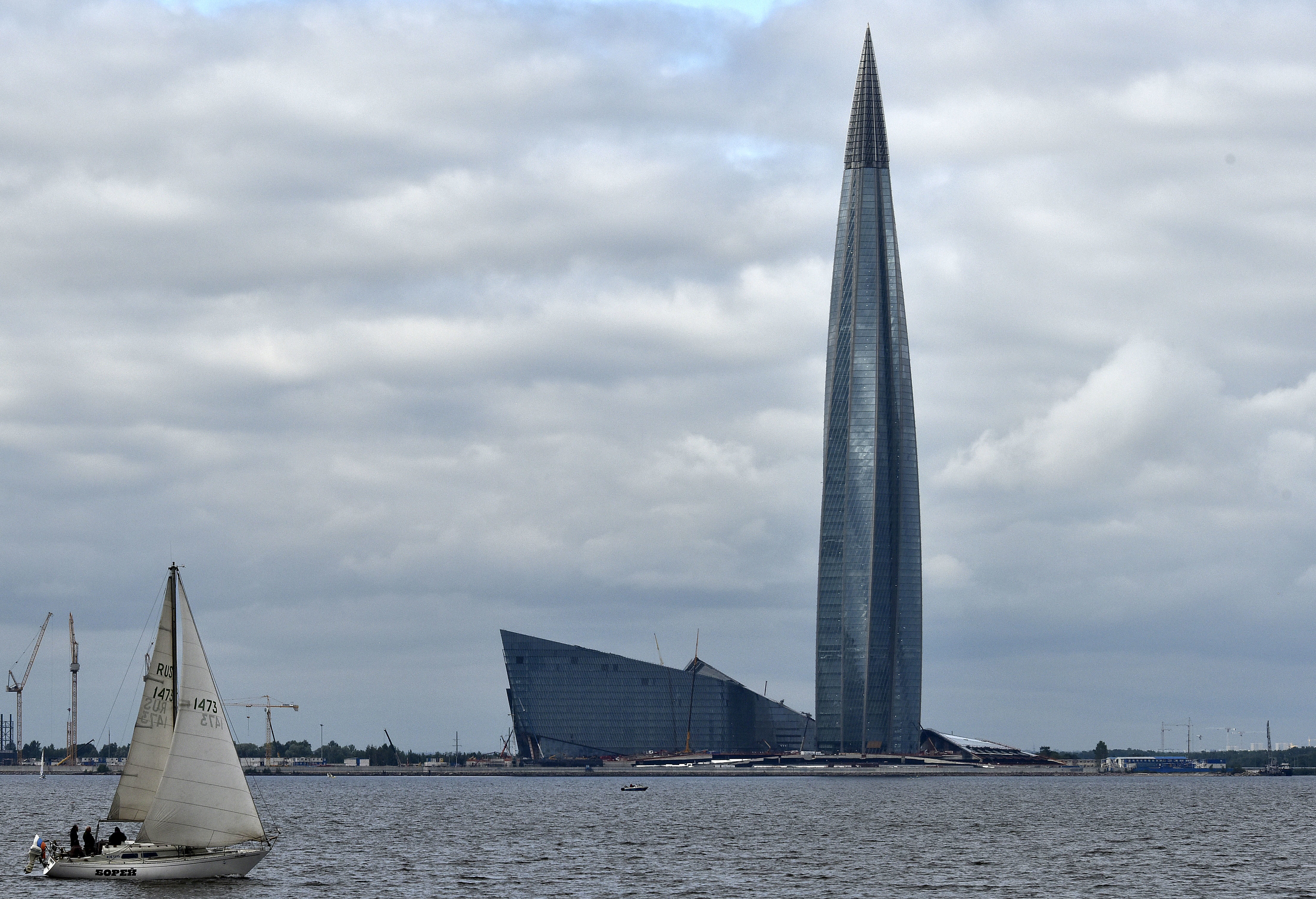 A sailboat passes the new Lakhta Center during the 2018 soccer World Cup in St. Petersburg, Russia, Sunday, July 8, 2018. The new headquarter of Russian energy company Gazprom is with 462 meters the tallest building in Europe. France will meet Belgium in the semifinal of the World Cup on Tuesday at the St. Petersburg Stadium. (AP Photo/Martin Meissner)