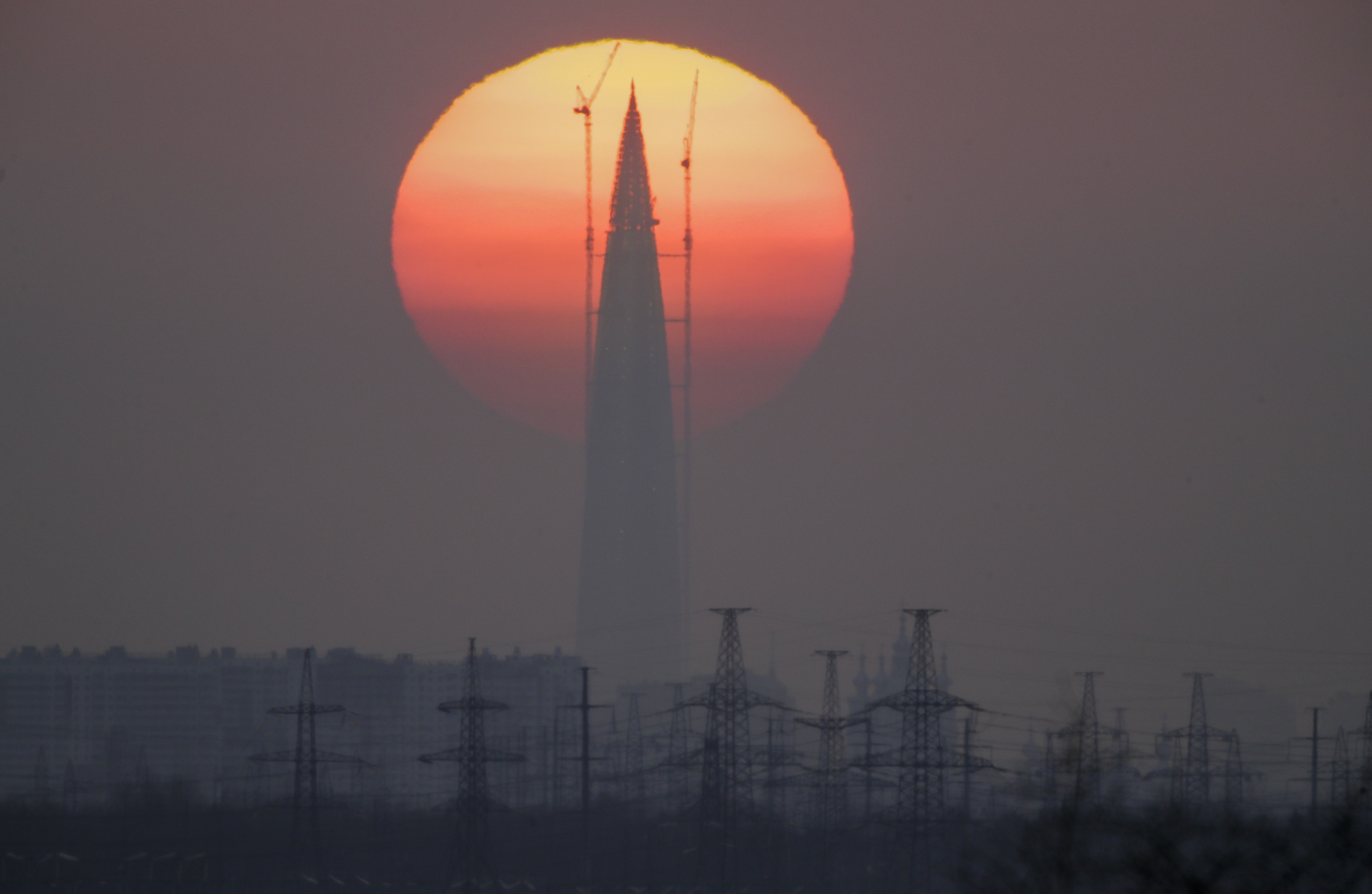 Business tower Lakhta Centre under construction, the headquarters of Russian gas monopoly Gazprom, is silhouetted against the sunset in St. Petersburg, Russia, Sunday, April 15, 2018. (AP Photo/Dmitri Lovetsky)