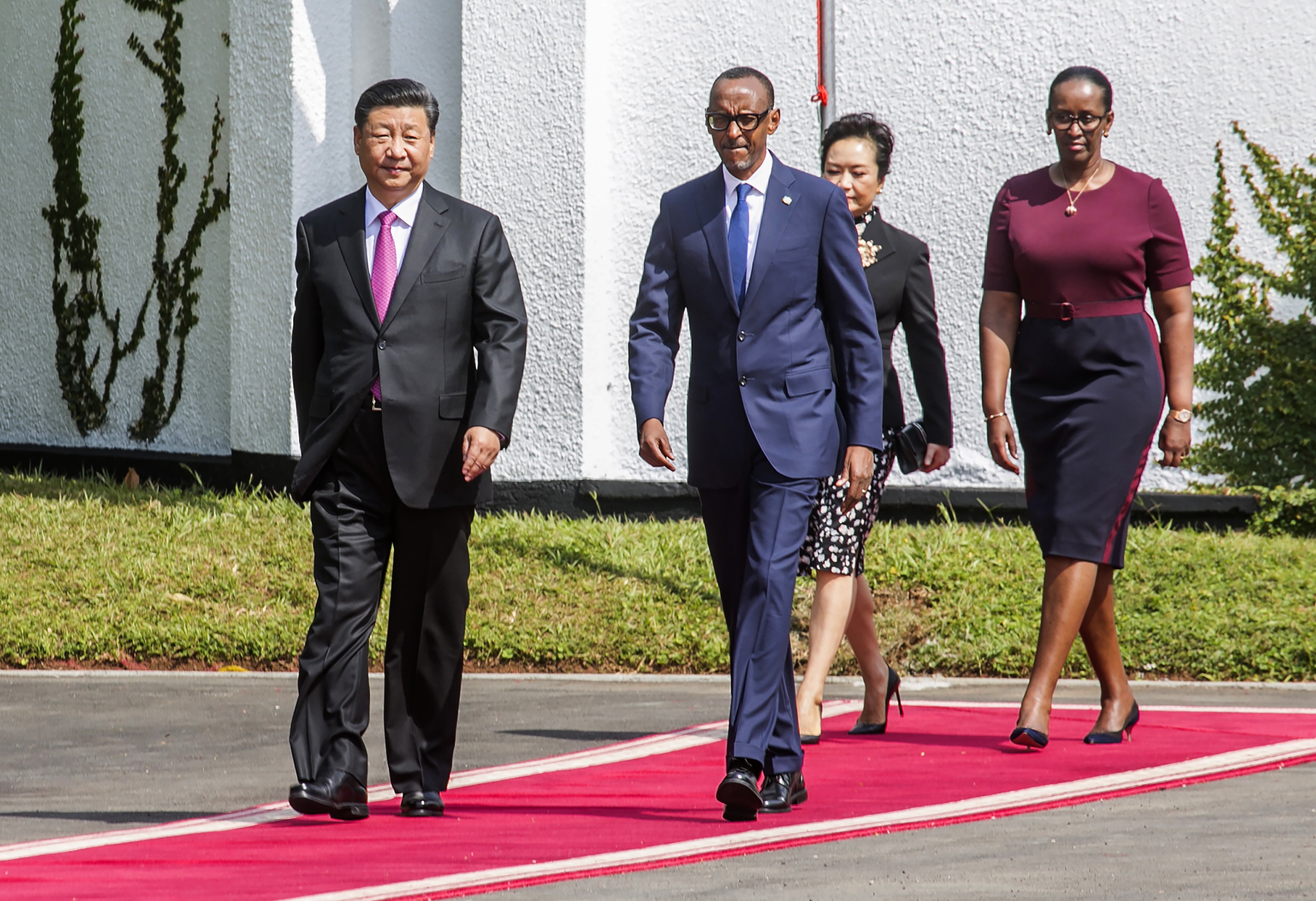 Rwandan President Paul Kagame, right, and Chinese President Xi Jinping, followed by their wives Jannette Kagame and Peng Liyuan arrive at Rwanda's State House on Monday, July 23, 2018. Xi is on a two-day state visit to Rwanda (AP Photo)