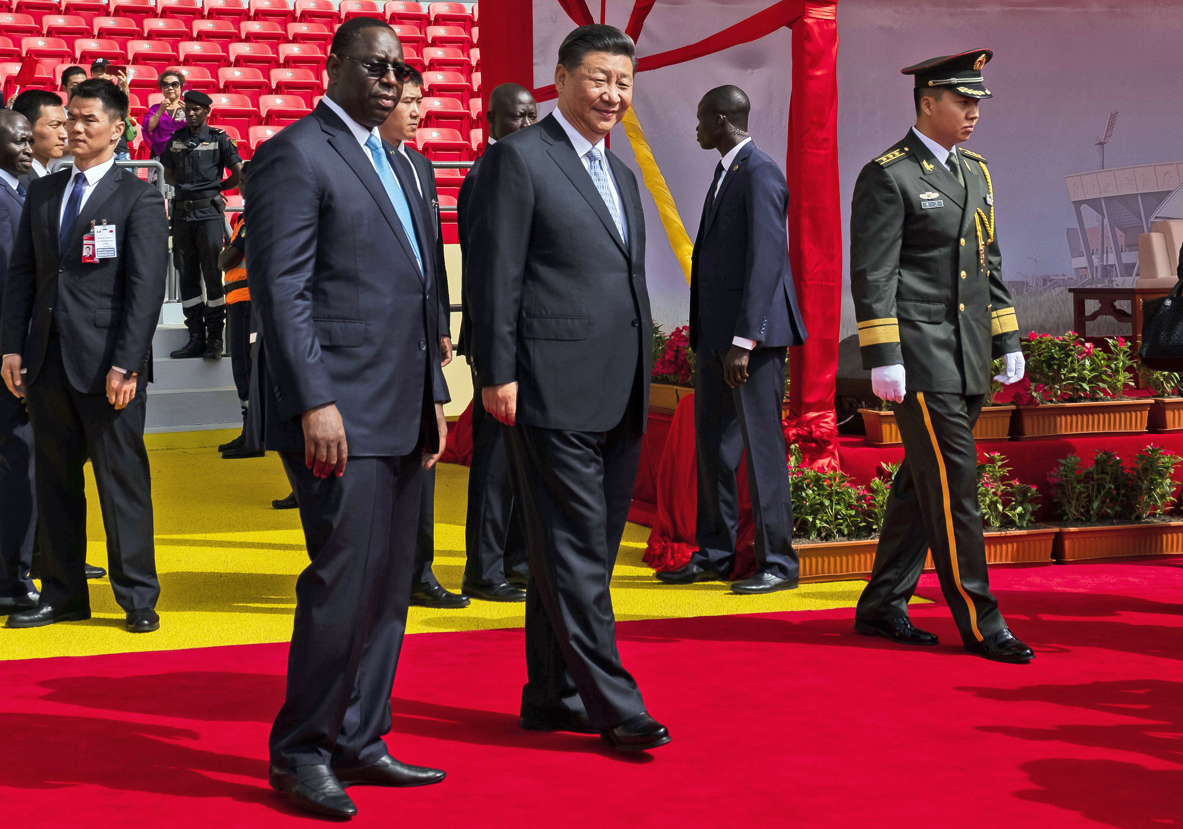 Chinese President Xi Jinping, center right, walks with Senegal's president Macky Sall during his state visit, in Dakar, Senegal, Sunday, July 22, 2018. Xi Jinping arrived in Africa on Saturday on a four-nation visit, seeking deeper military and economic ties. (AP Photo/Xaume Olleros)