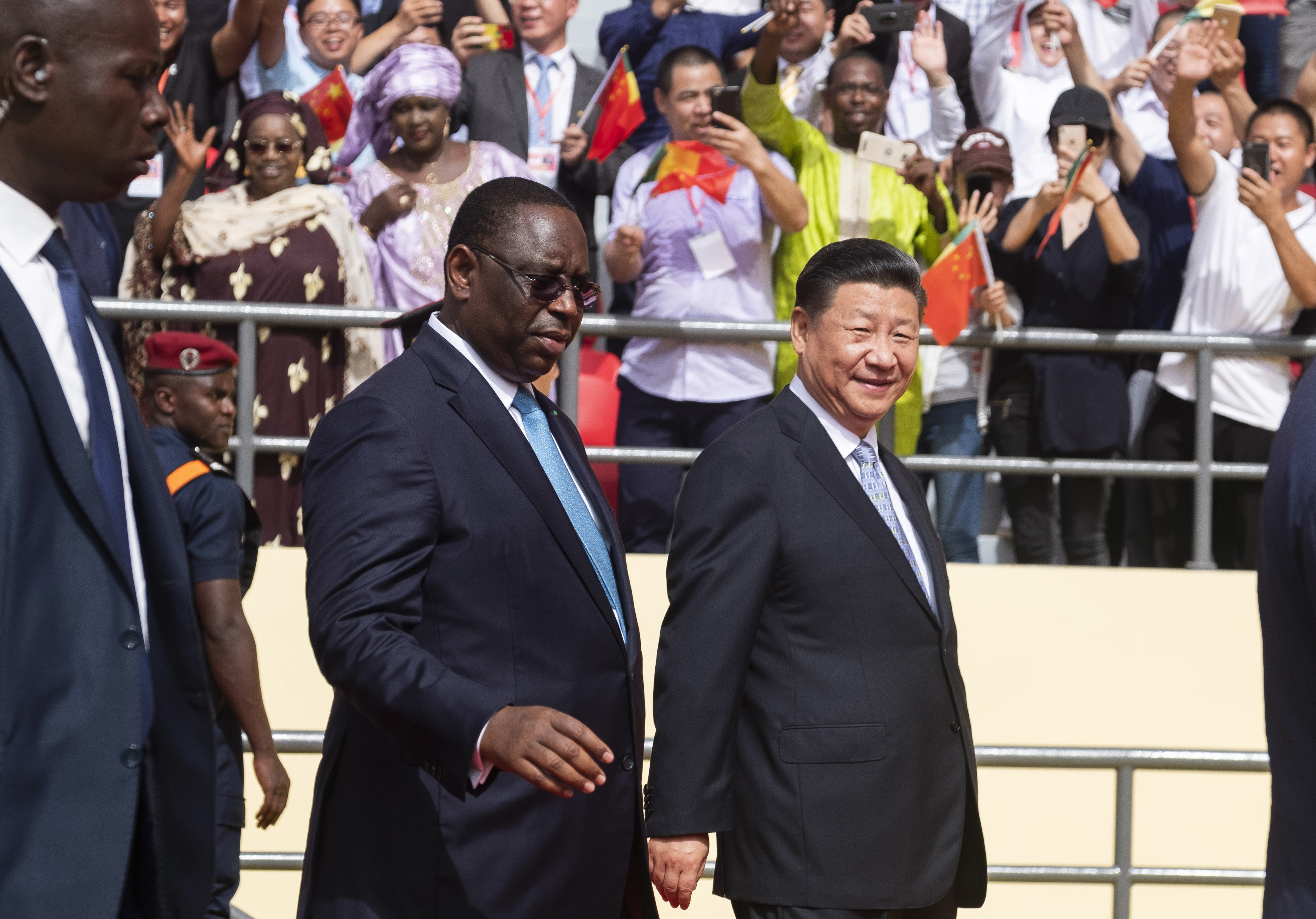 Chinese President Xi Jinping, right walks with Senegal's president Macky Sall during his state visit, in Dakar, Senegal, Sunday, July 22, 2018. Xi Jinping arrived in Africa on Saturday on a four-nation visit, seeking deeper military and economic ties. (AP Photo/Xaume Olleros)