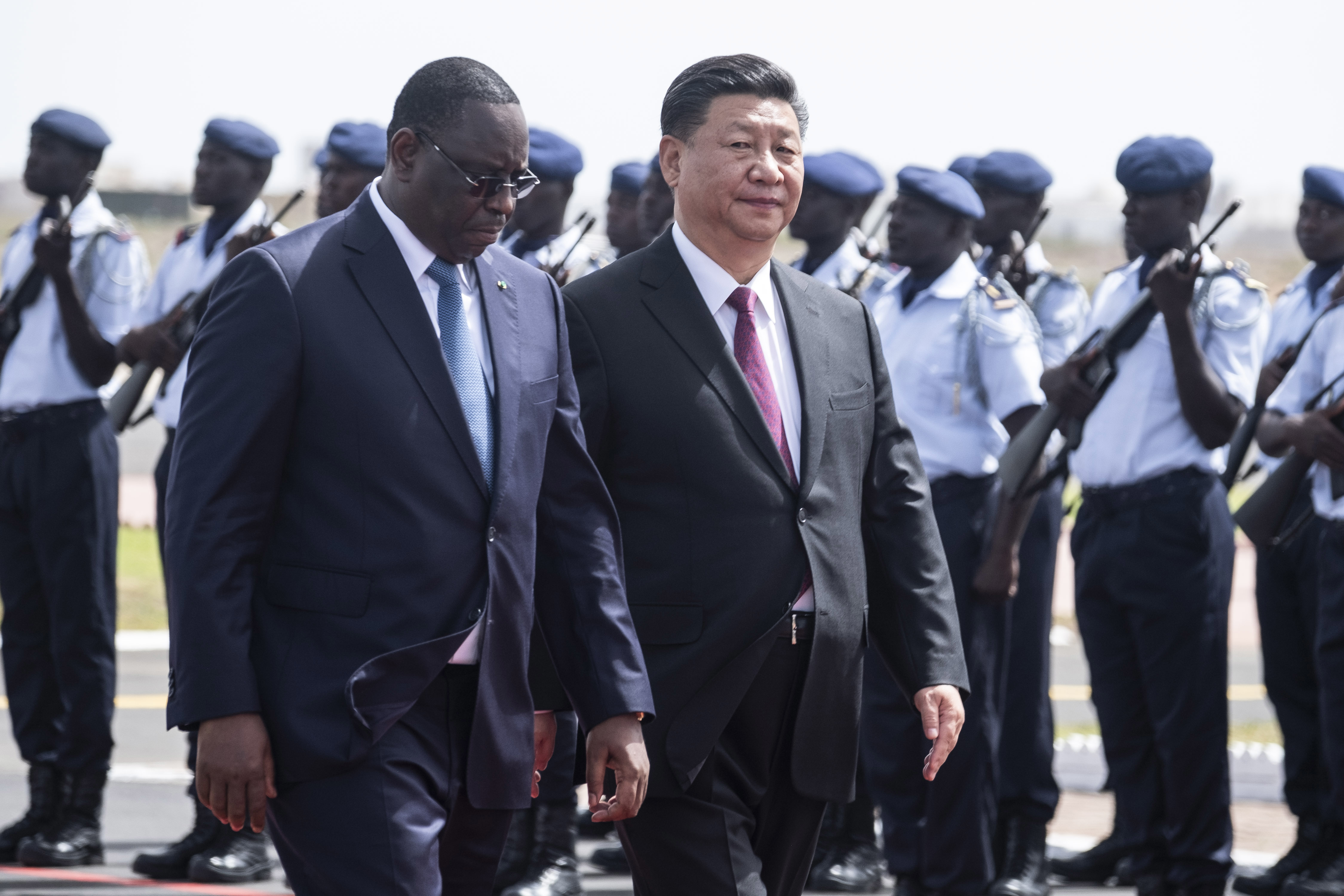 Senegal president Macky Sall, left, and Chinese President Xi Jinping, inspect the honour guard during a state visit in Dakar, Senegal, Saturday, July 21, 2018. Chinese President Xi Jinping arrived in Africa on Saturday on a four-nation visit seeking deeper military and economic ties.(AP Photo/Xaume Olleros)