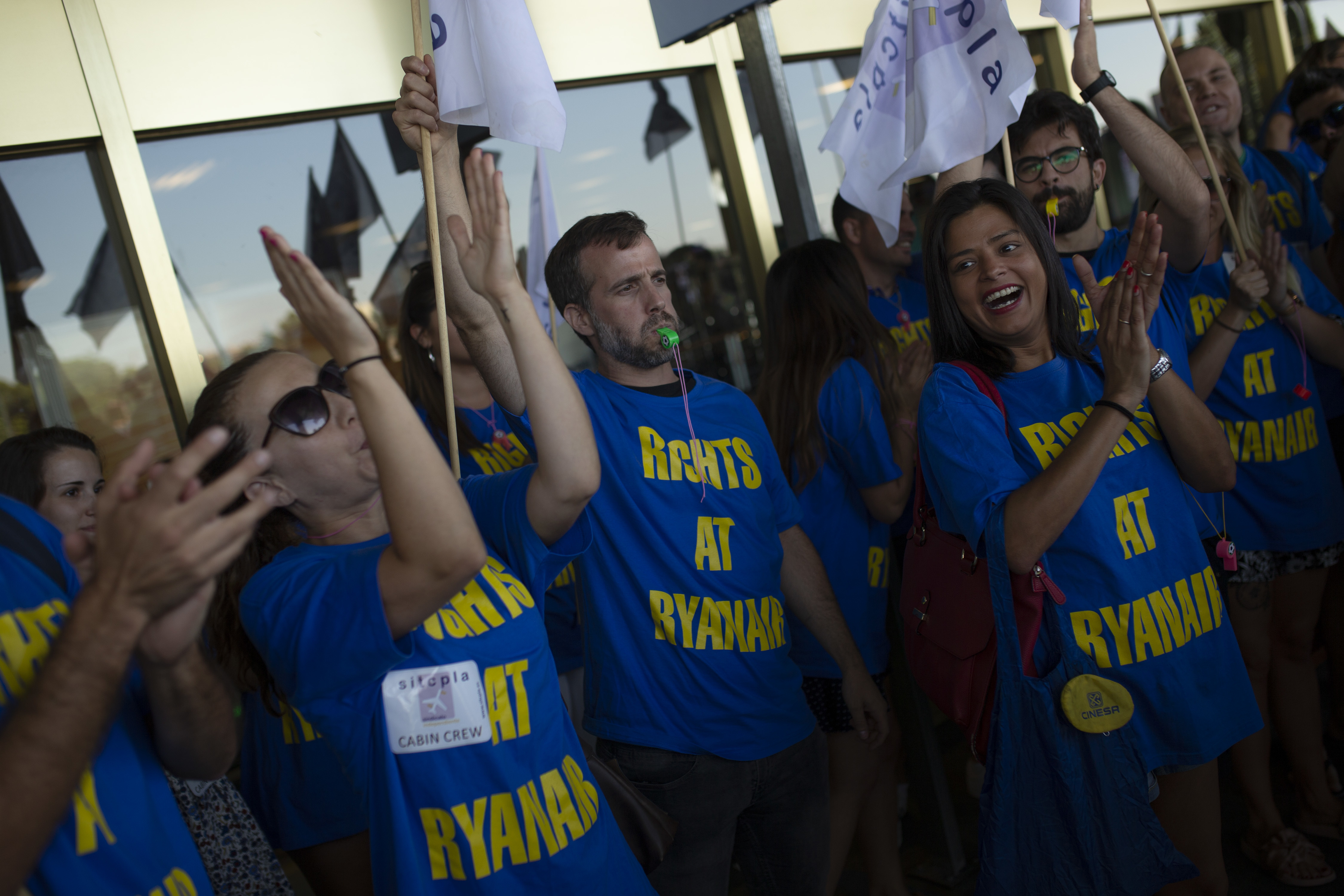 Ryanair airline workers shout slogans during a small protest during the first of two days cabin crew strike at Adolfo Suarez-Barajas international airport in Madrid, Wednesday, July 25, 2018. Cabin crew workers for low-cost airline Ryanair went on strike in four European countries over working conditions, forcing thousands of passengers to make last-minute travel adjustments at the peak of the summer holiday season. (AP Photo/Francisco Seco)