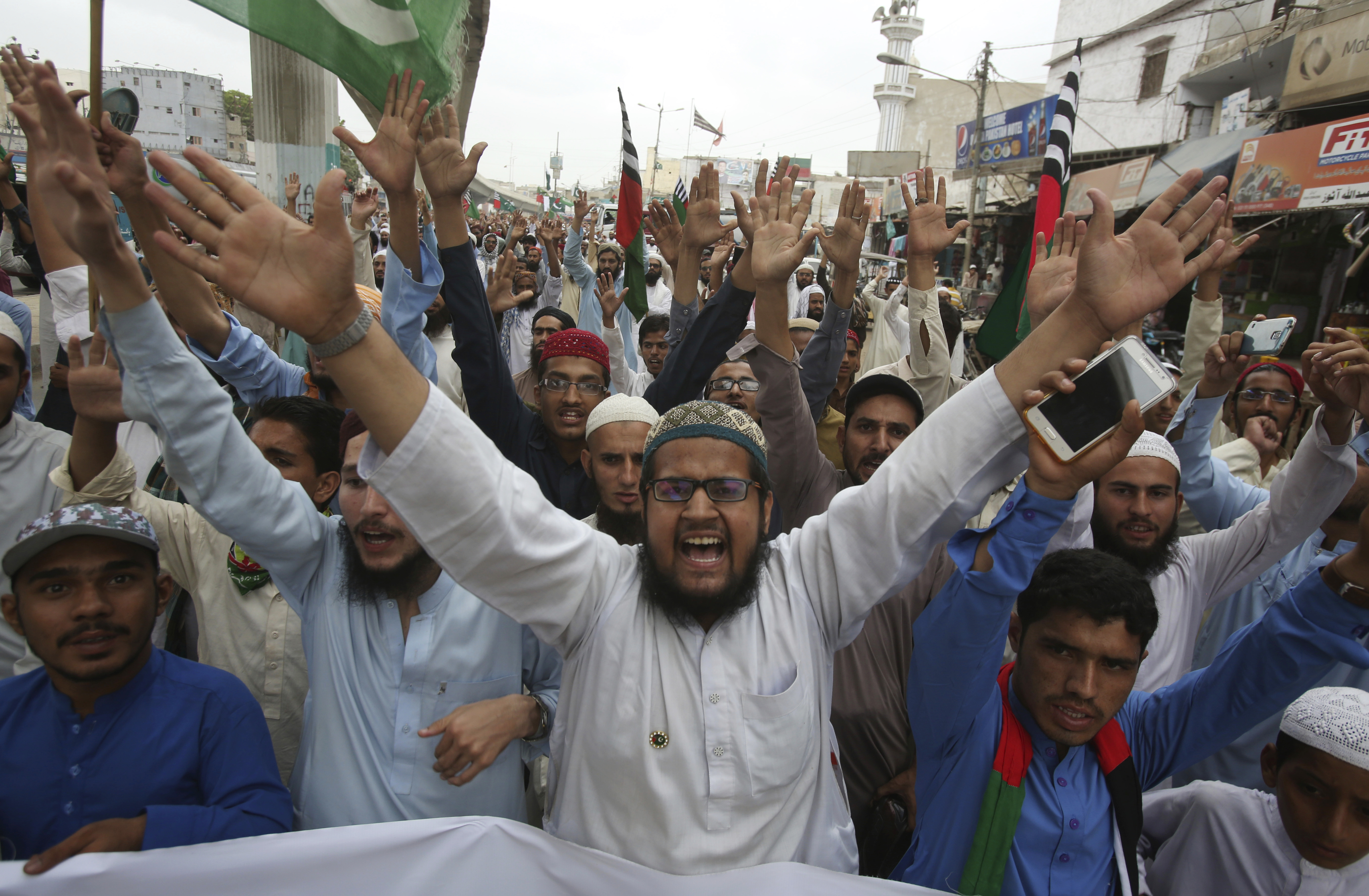Pakistani protesters demonstrate to condemn the planned anti-Islam cartoon contest, in Karachi, Pakistan, Thursday, Aug. 30, 2018. Thousands of hard-line Islamists angered over a far-right Dutch lawmaker's plans to hold a Prophet Muhammad cartoon contest marched toward Pakistan's capital. (AP Photo/Fareed Khan)