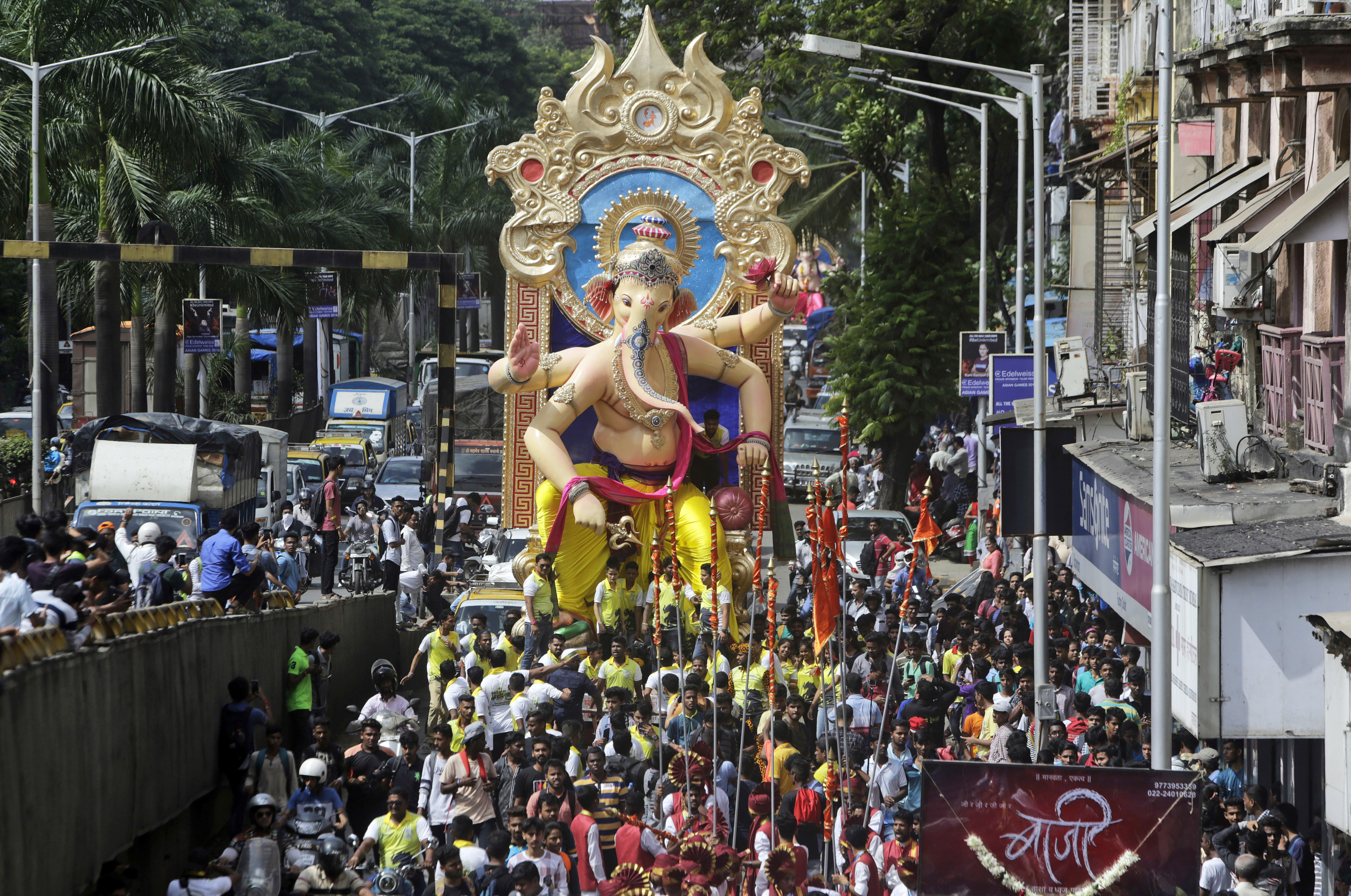 Devotees carry an idol of Hindu god Ganesha from a studio to a temporary place of worship for the upcoming Ganesha Chaturthi festival in Mumbai, India, Saturday, Sept. 1, 2018. Ganesha Chaturthi, the festival celebrating the birth of elephant-headed Ganesha, will begin Sept. 13. (AP Photo/Rajanish Kakade)