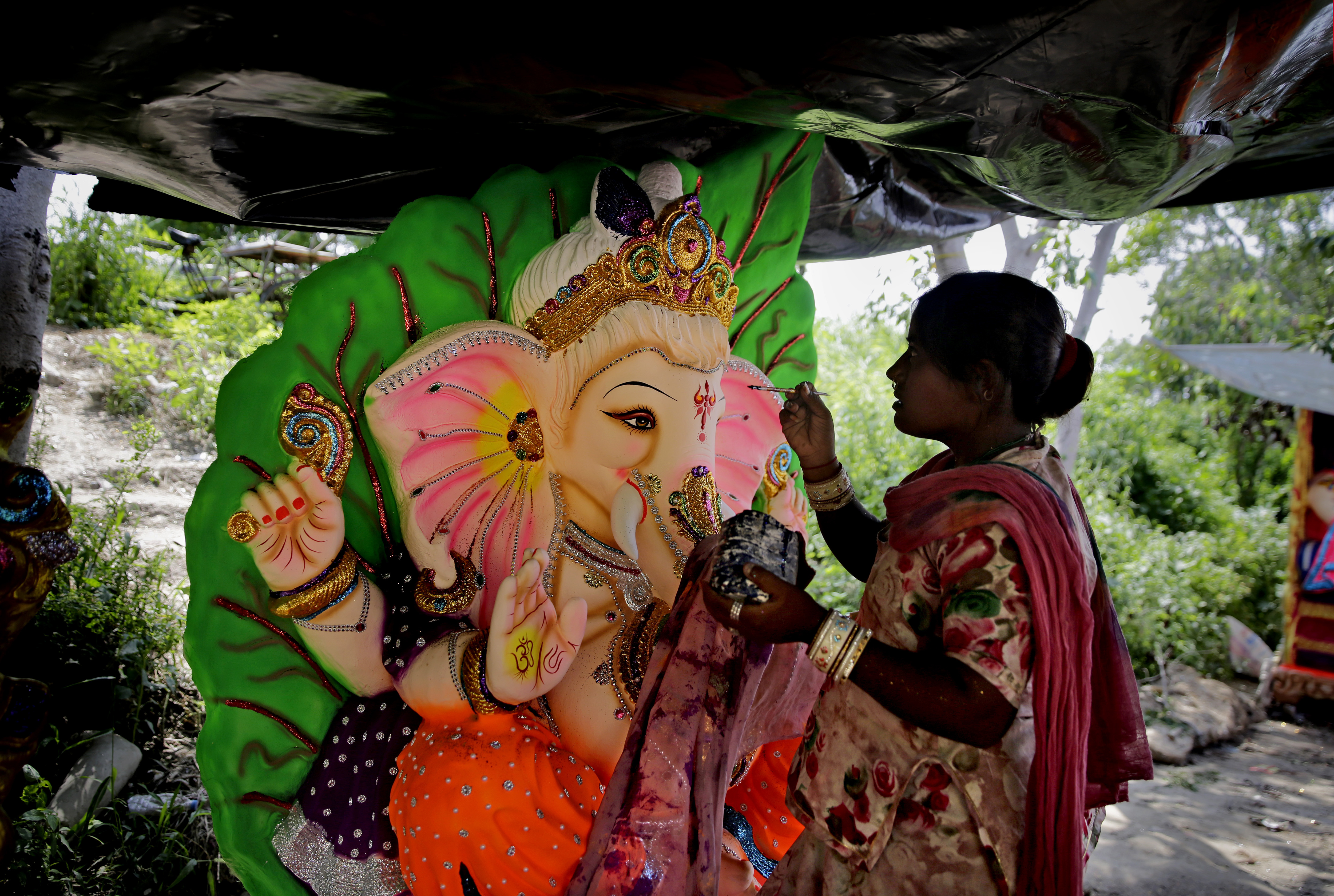 An Indian artist prepares an idol of Hindu god Ganesha in New Delhi, India, Wednesday, Sept. 12, 2018. The idols are being prepared ahead of the 'Ganesh Chaturthi' festival that celebrates the birthday of the elephant headed god. (AP Photo/Altaf Qadri)
