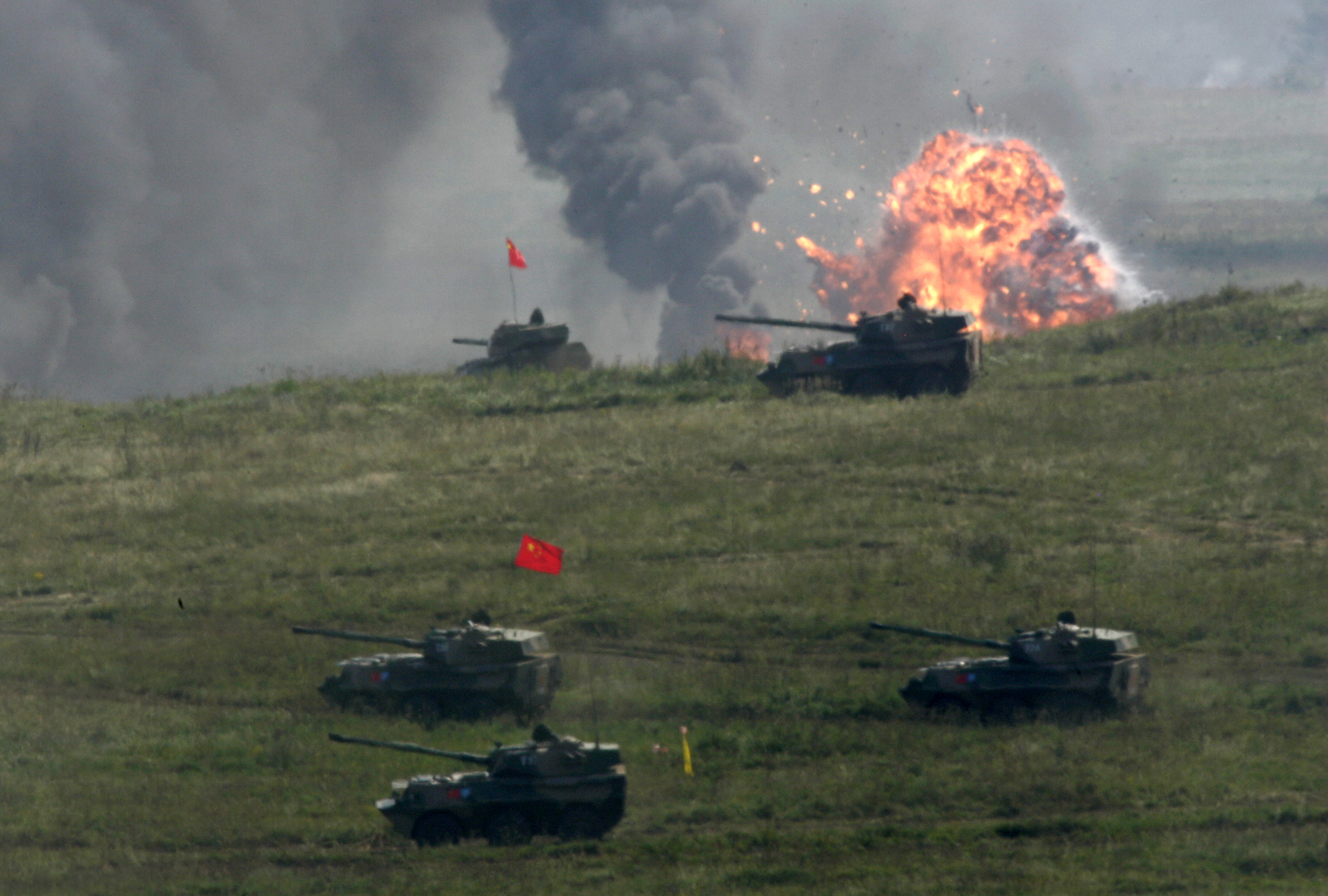 Chinese self-propelled howitzers move across a field during joint military exercises at Chebarkul testing range on Friday, Aug. 17, 2007. Russian and Chinese forces on Friday held their first joint maneuvers on Russia's territory _ an exercise intended to demonstrate their growing military ties and a shared desire to counter U.S. global clout. The war games in Russia's southern Ural Mountains involved some 6,000 troops from Russia and China and also a handful of soldiers from four ex-Soviet Central Asian nations that are part of the Shanghai Cooperation Organization, a regional group dominated by Moscow and Beijing.  (AP Photo/Ivan Sekretarev)