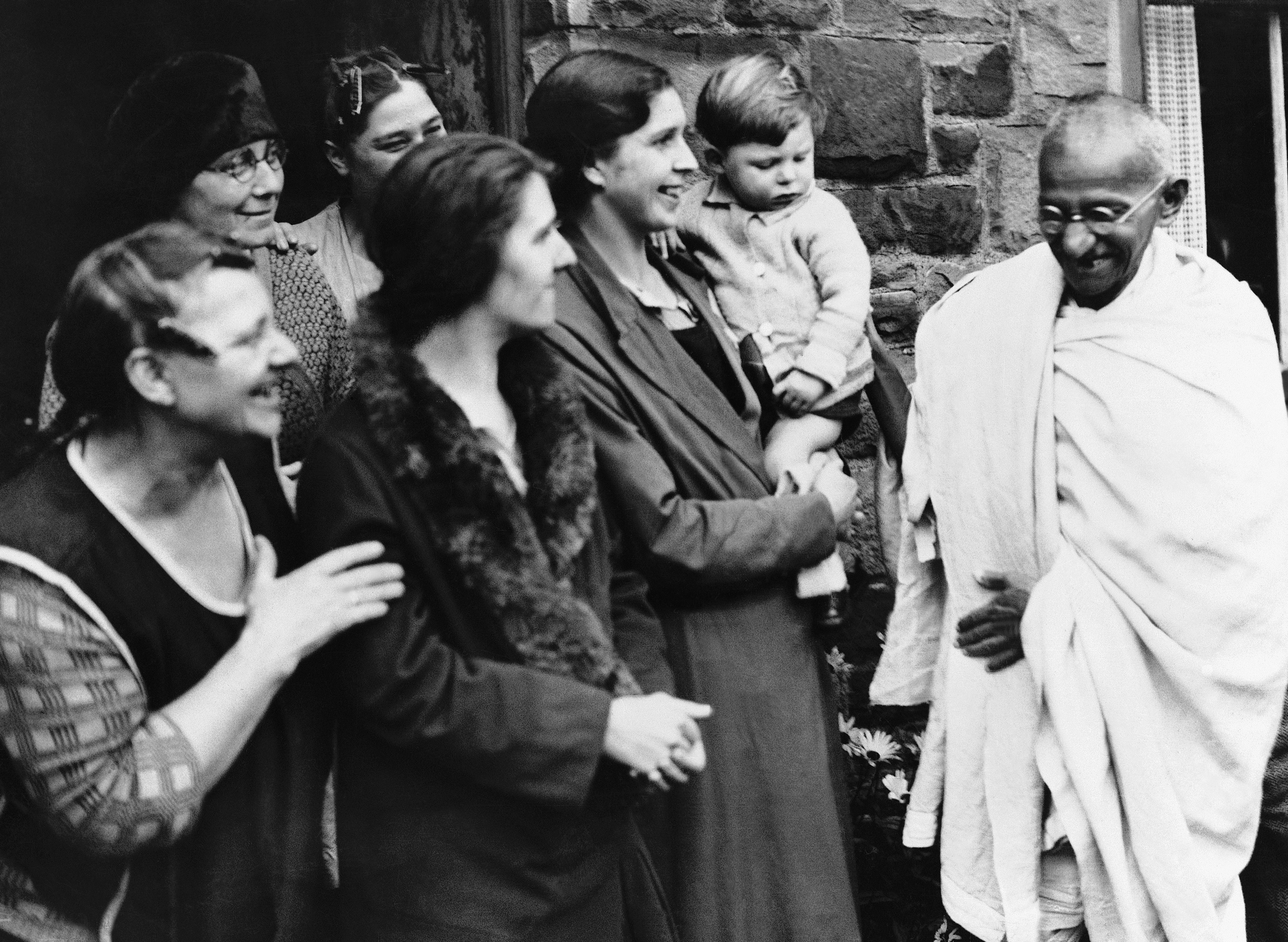 Mohandas Karamchand Gandhi visiting the workers in their cottages at Spring Vale, England on Sept. 26, 1931, during his inspection of the Lancashire Cotton industry's labour conditions.  (AP Photo/Staff/Puttnam)