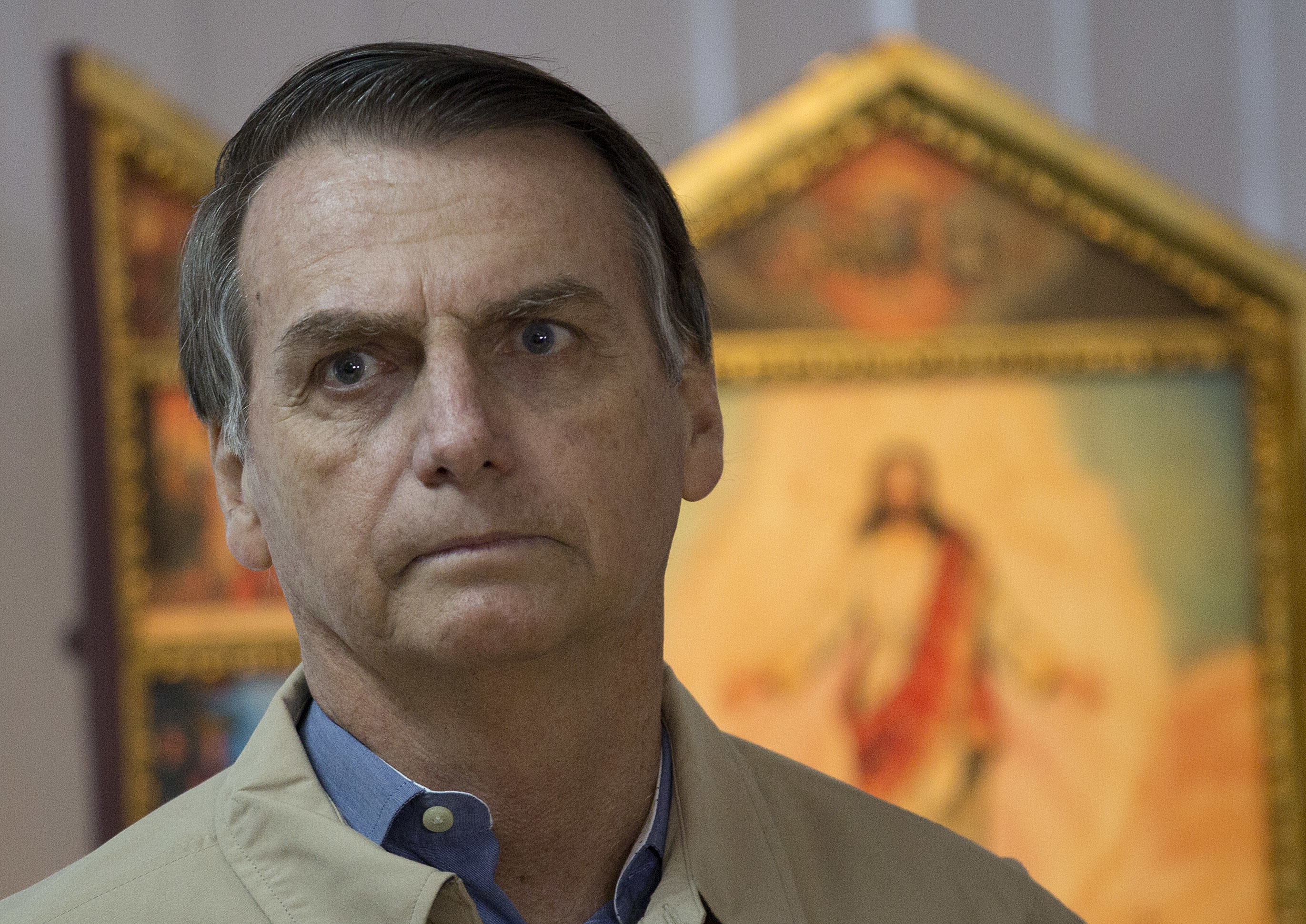Presidential candidate Jair Bolsonaro poses for a photo during a meeting with Rio de Janeiro's Archbishop Dom Orani Tempesta in Rio de Janeiro, Brazil, Wednesday, Oct. 17, 2018. Bolsonaro won the first round of the presidential election Oct. 7 with 46 percent of the vote, but since he failed to top 50 percent, he is in a second-round ballot on Oct. 28. (AP Photo/Silvia Izquierdo)