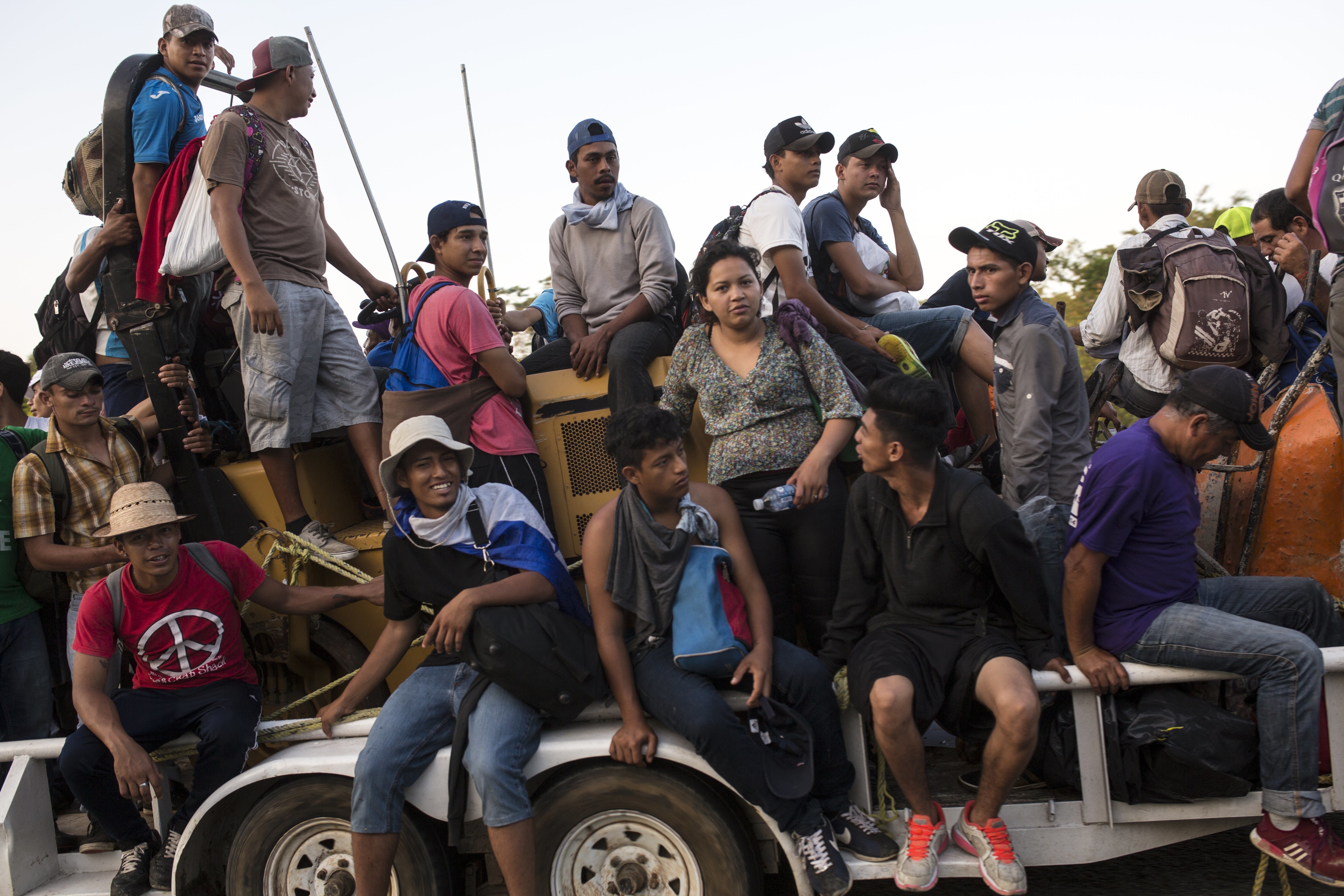 Central American migrants traveling with a caravan to the U.S. crowd onto a tractor as they make their way to Mapastepec, Mexico, Wednesday, Oct. 24, 2018. Thousands of Central American migrants renewed their hoped-for march to the United States on Wednesday, setting out before dawn with plans to travel another 45 miles (75 kilometers) of the more than 1,000 miles that still lie before them. (AP Photo/Rodrigo Abd)
