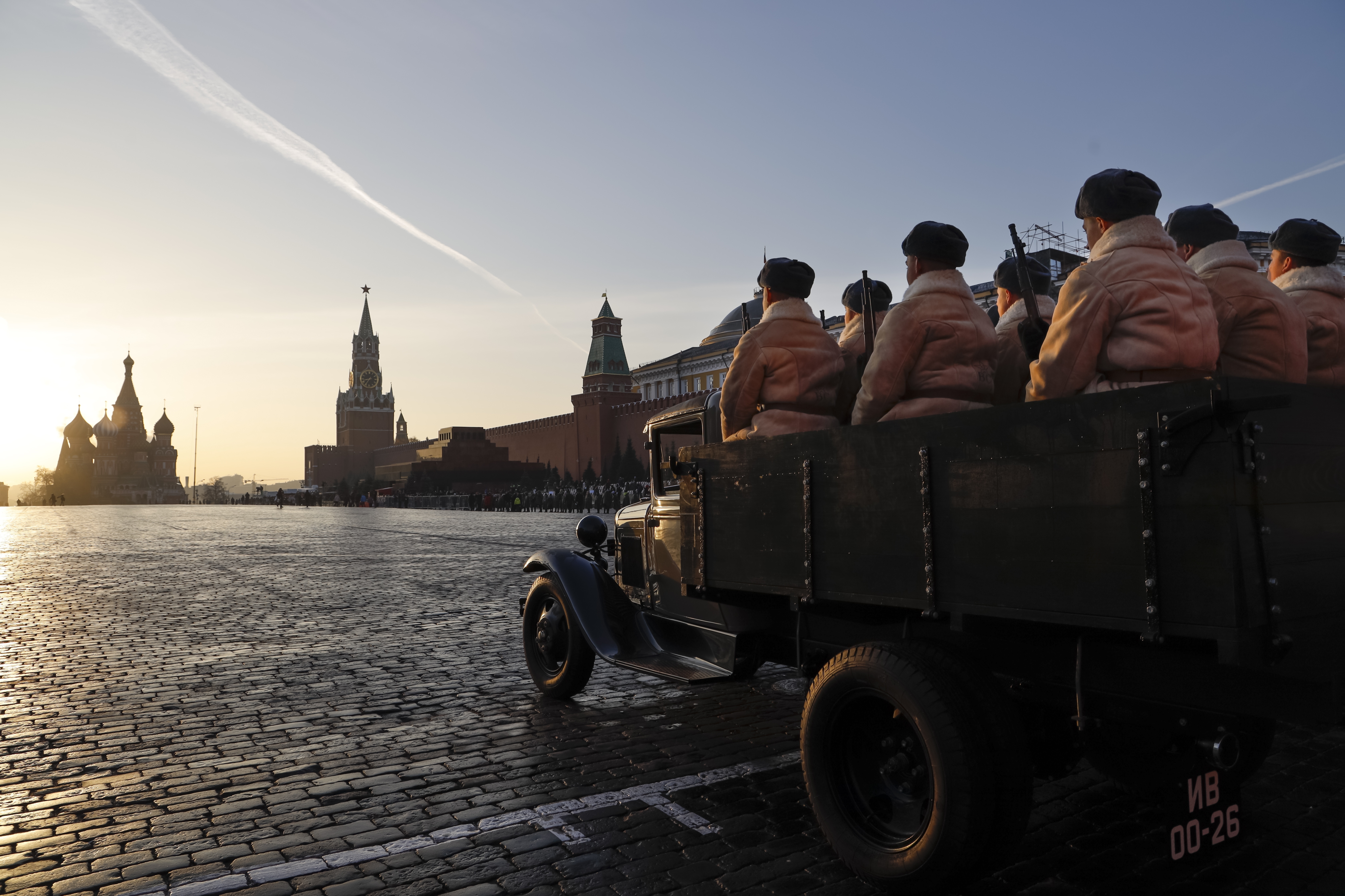 Russian soldiers dressed in Red Army World War II uniform sit in the back of a GAZ AA during the Nov. 7 parade, with St. Basil Cathedral and the Spasskaya Tower in the background, in Red Square, in Moscow, Russia, Wednesday, Nov. 7, 2018. The parade marked the 77th anniversary of a World War II historic parade in Red Square and honored the participants in the Nov. 7, 1941 parade who headed directly to the front lines to defend Moscow from the Nazi forces. (AP Photo/Alexander Zemlianichenko)