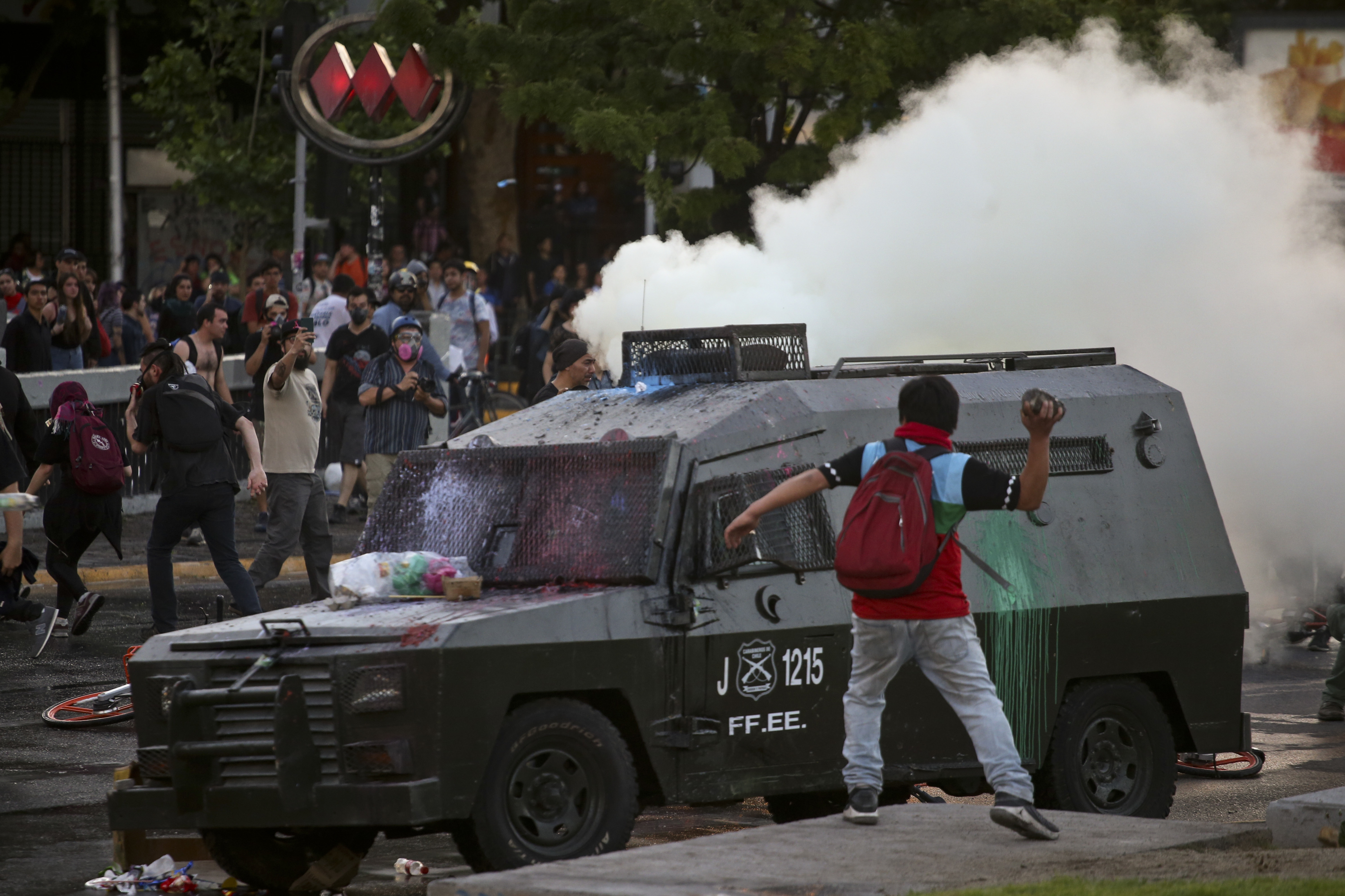 Demonstrators clash with police, after the death of Mapuche indigenous man Camilo Catrillanca during a police operation in La Araucania region of the country, in Santiago, Chile, Thursday, Nov. 15, 2018. The death of Catrillanca, shot in the head when the police was chasing unidentified car thieves, unleashed protests and violence in the troubled indigenous region of La Araucania, as well as in Santiago. (AP Photo/Esteban Felix)