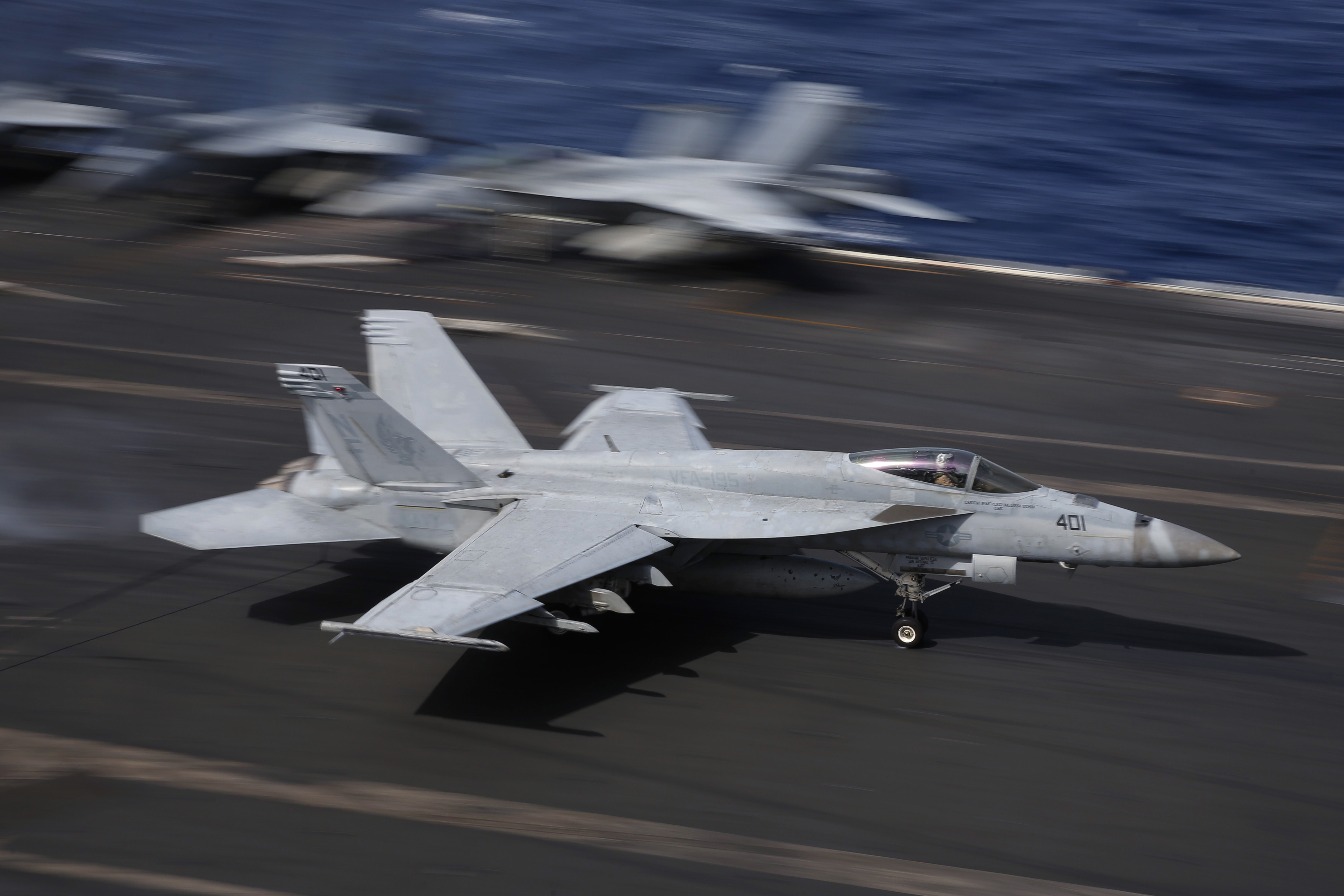 An F/A-18 Super Hornet fighter jet lands on the deck of the U.S. Navy USS Ronald Reagan in the South China Sea, Tuesday, Nov. 20, 2018. China is allowing a U.S. Navy aircraft carrier and its battle group to make a port call in Hong Kong after it turned down similar request amid tensions with Washington.  (AP Photo/Kin Cheung)