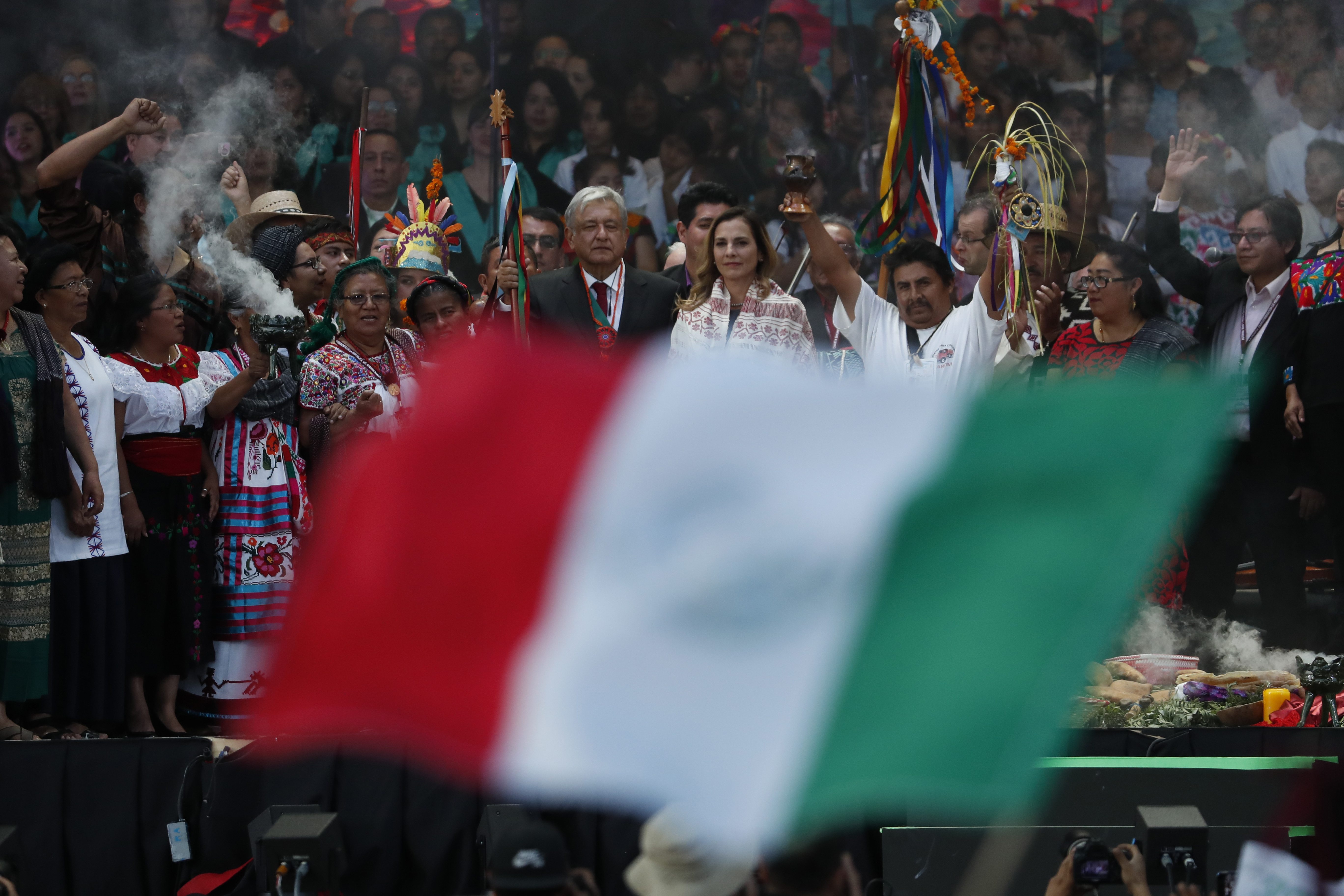 Mexico's new President Andres Manuel Lopez Obrador holds a chieftain's staff during a traditional indigenous ceremony at the Zocalo, in Mexico City, Saturday, Dec. 1, 2018. Mexicans are getting more than just a new president Saturday. The inauguration of Lopez Obrador will mark a turning point in one of the world's most radical experiments in opening markets and privatization. (AP Photo/Moises Castillo)