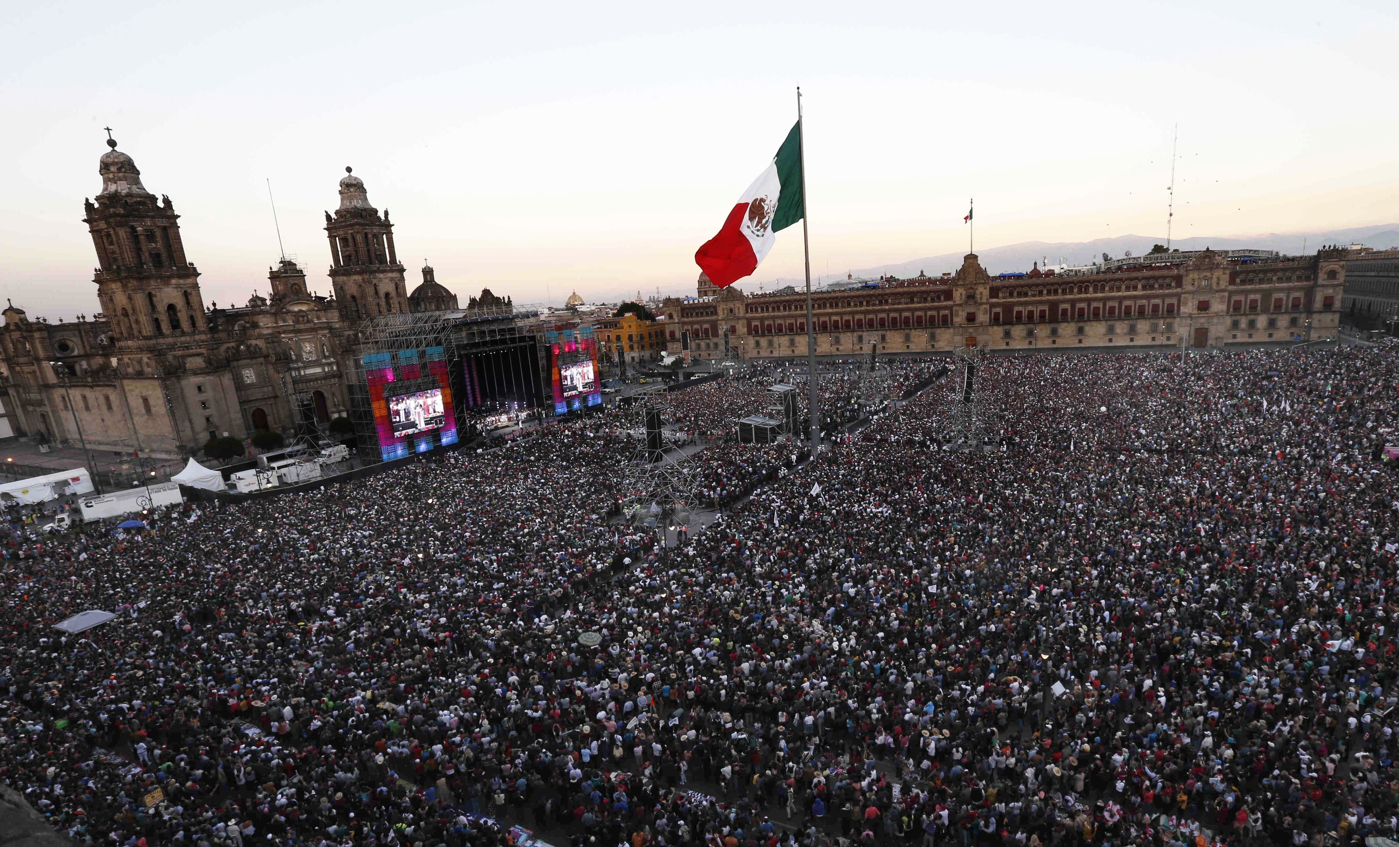 Celebrants take part in a traditional ceremony in which Mexico's newly sworn-in President Andres Manuel Lopez Obrador is formally anointed leader by indigenous groups, at the Zocalo, in Mexico City, Saturday, Dec. 1, 2018. Mexico has more than 70 indigenous communities, and Lopez Obrador has pledged to end centuries of poverty and marginalization for them. (AP Photo/Marco Ugarte)