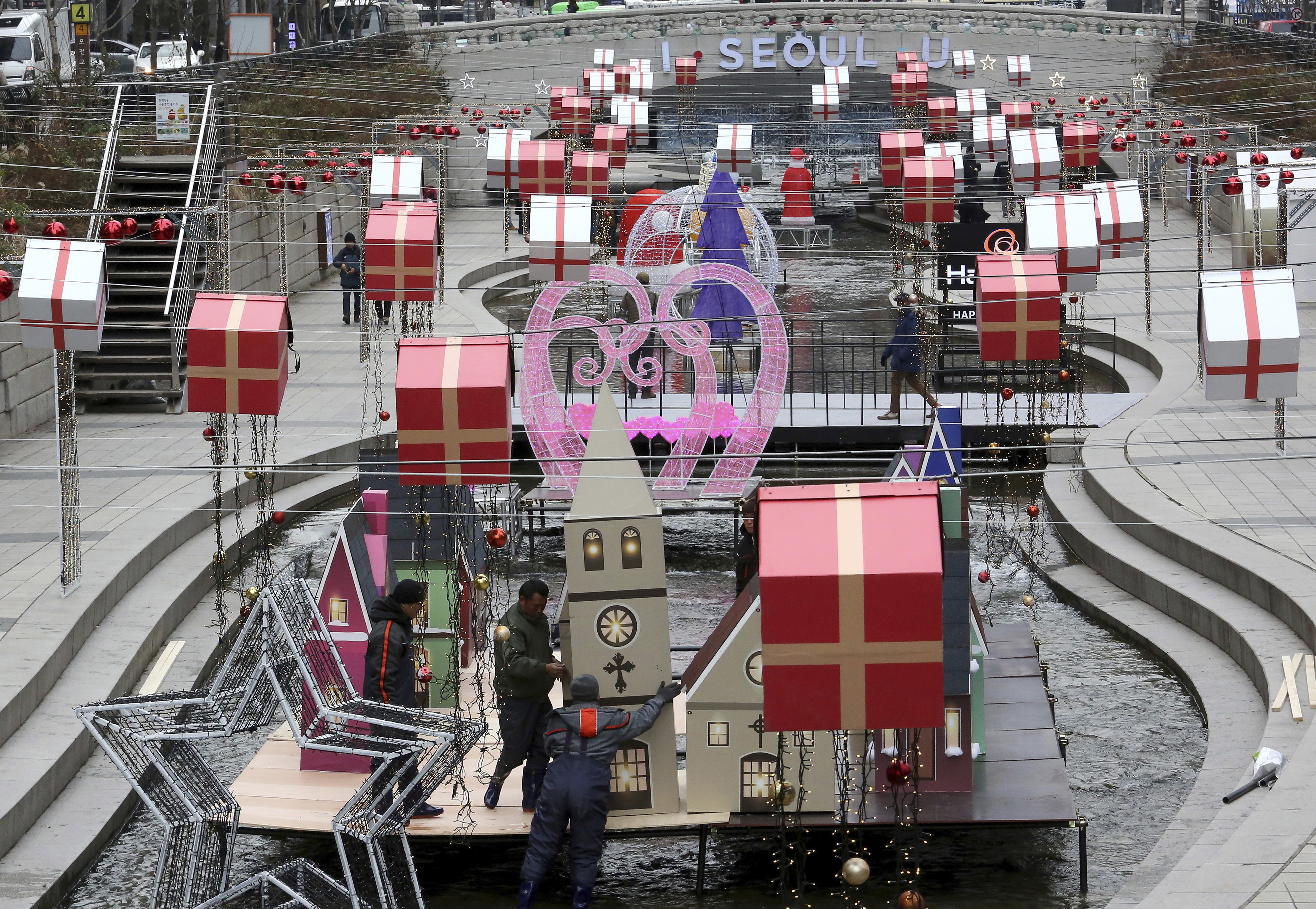 Workers display decorations to celebrate Christmas and New Year over the Cheonggye Stream in Seoul, South Korea, Tuesday, Dec. 11, 2018. (AP Photo/Ahn Young-joon)