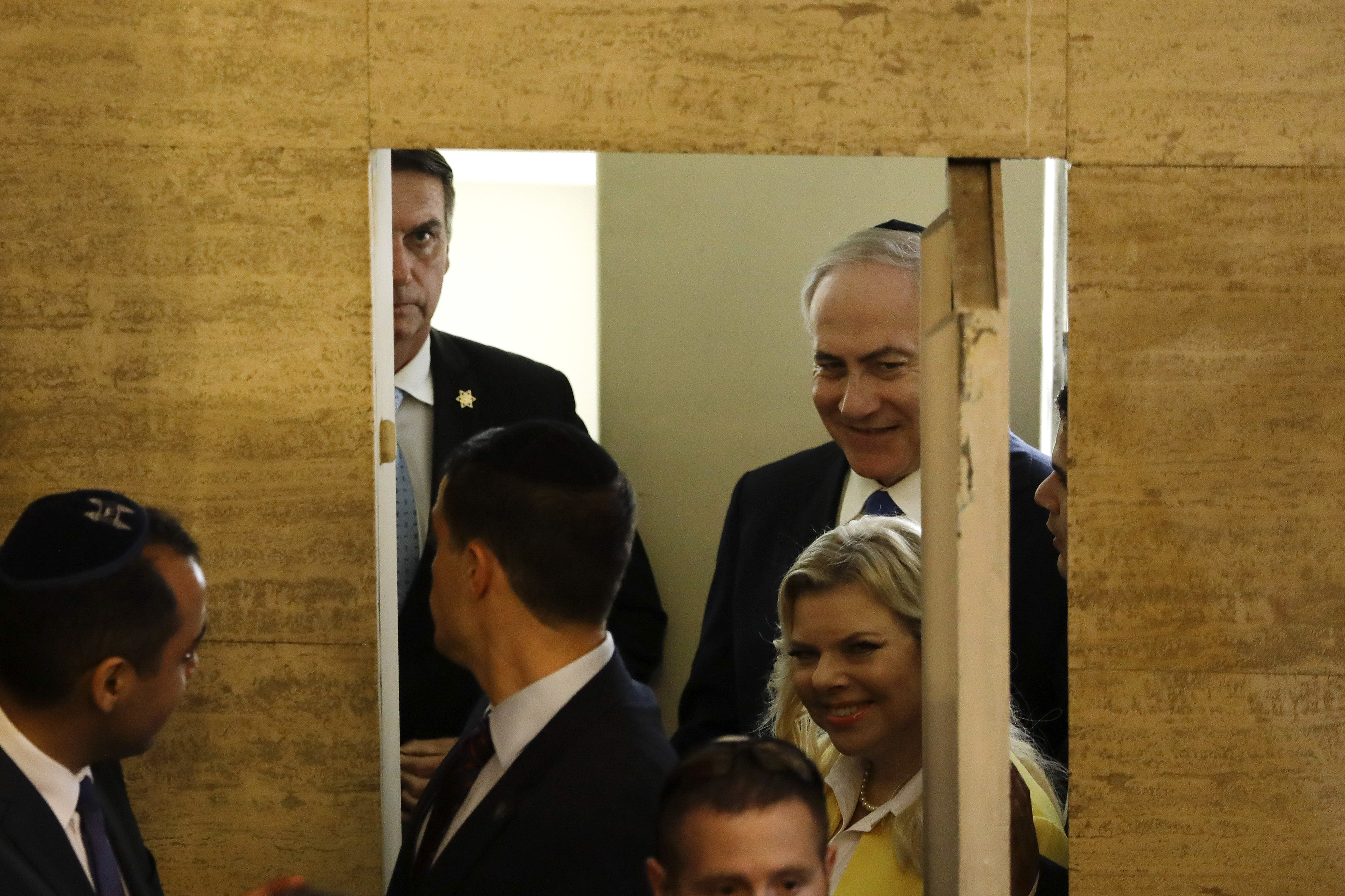 Brazil's President-elect Jair Bolsonaro, left back, arrives with Israel's Prime Minister Benjamin Netanyahu and his wife Sara, to the Kehilat Yaacov synagogue, in Rio de Janeiro, Brazil, Friday, Dec. 28, 2018. According to the Israeli Embassy, Netanyahu will stay in Rio until Tuesday, when he will travel to Brasilia for the presidential inauguration. (Leo Correa/Pool Photo via AP)