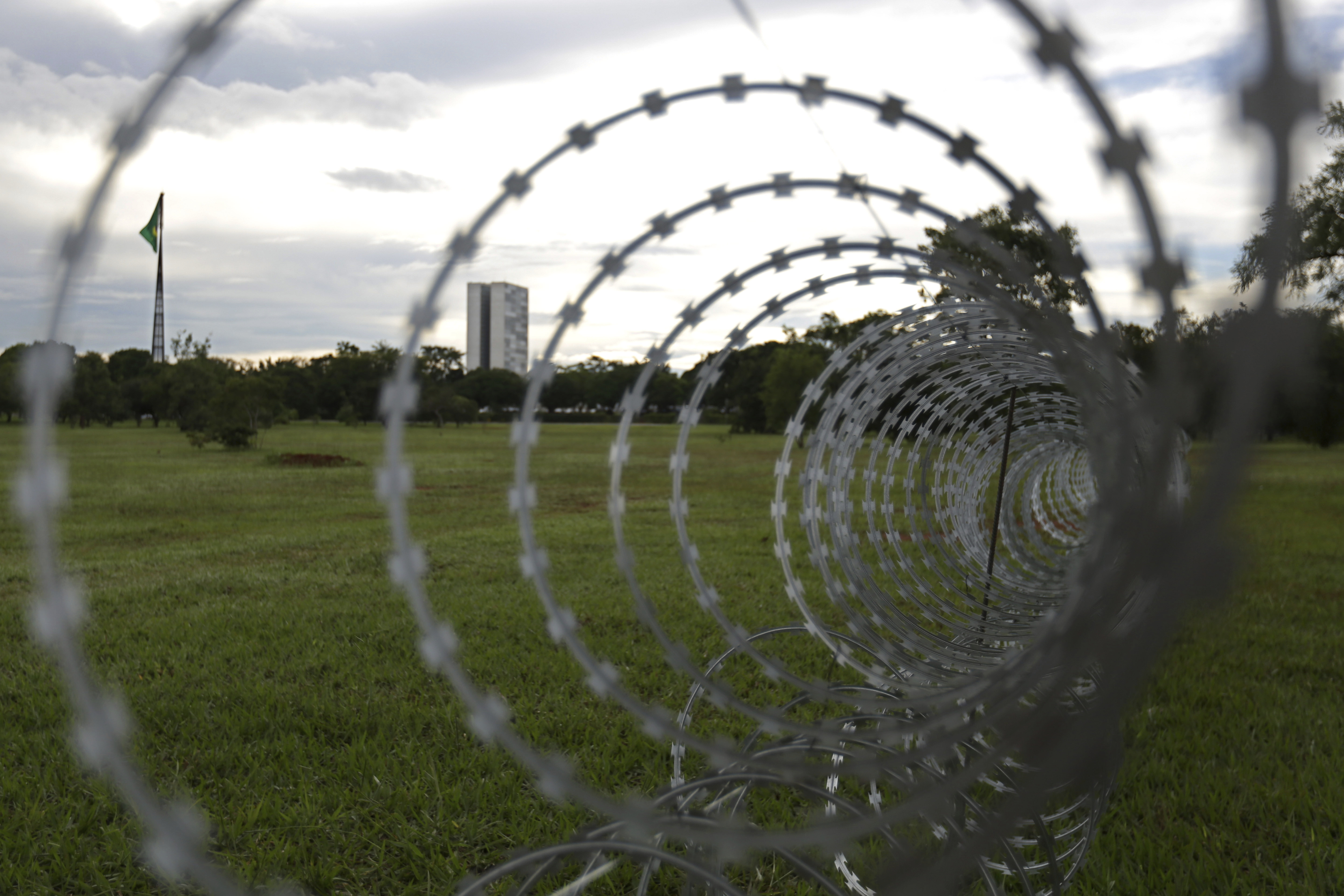 Concertina wire is installed around the Esplanade of Ministries as part of the preparations for the inauguration ceremony for President-elect Jair Bolsonaro, in Brasilia, Brazil, Friday, Dec. 28, 2018. The Secretary of Public Security in Brasilia said that they are expecting as many as 500,000 people to attend the ceremony. Brazil's military has deployed anti-aircraft missiles and fighter jets to protect the event from the air. On the ground, more than 3,000 police and military will take to the streets. (AP Photo/Eraldo Peres)