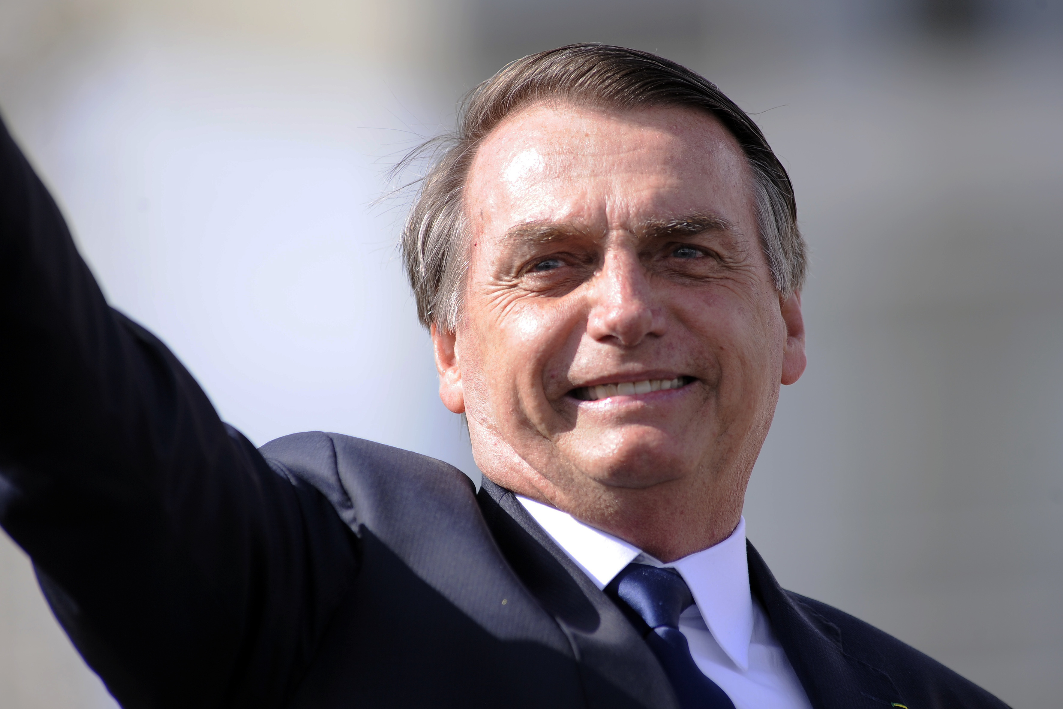 01 January 2019, Brazil, Brasilia: Brazil's President Jair Bolsonaro waves as he drives through the capital Brasilia in an open Rolls Royce. The ultra-right ex-military Jair Bolsonaro has been sworn in as the new president of Brazil. The 63-year-old took his oath of office in Congress on Tuesday. Photo by: Alan Morici/picture-alliance/dpa/AP Images