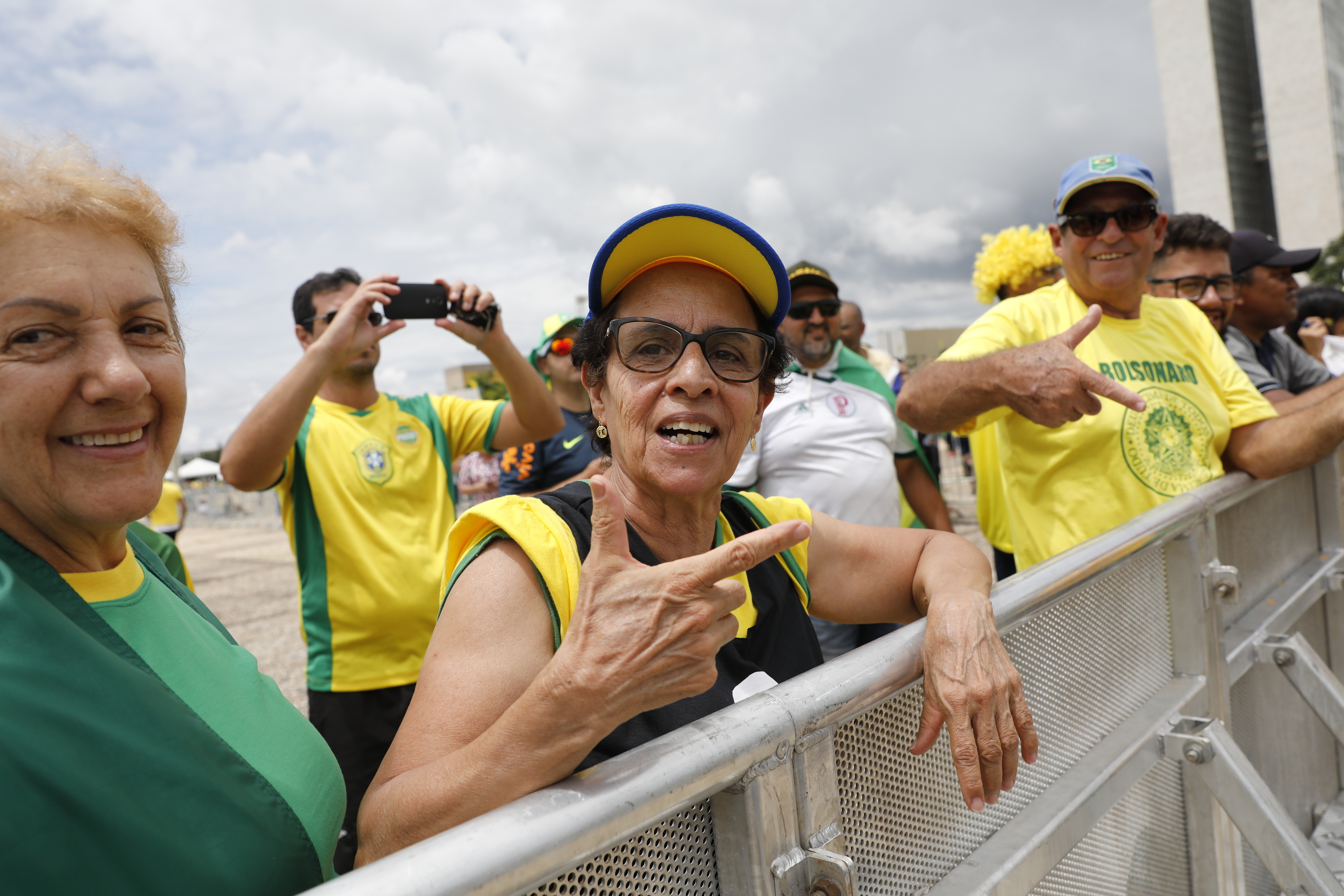 Locals show their support for Brazil's President Elect Jair Bolsonaro prior to his inauguration, in Brasilia, Brazil, Tuesday Jan. 1, 2019. (AP Photo/Silvia Izquierdo)
