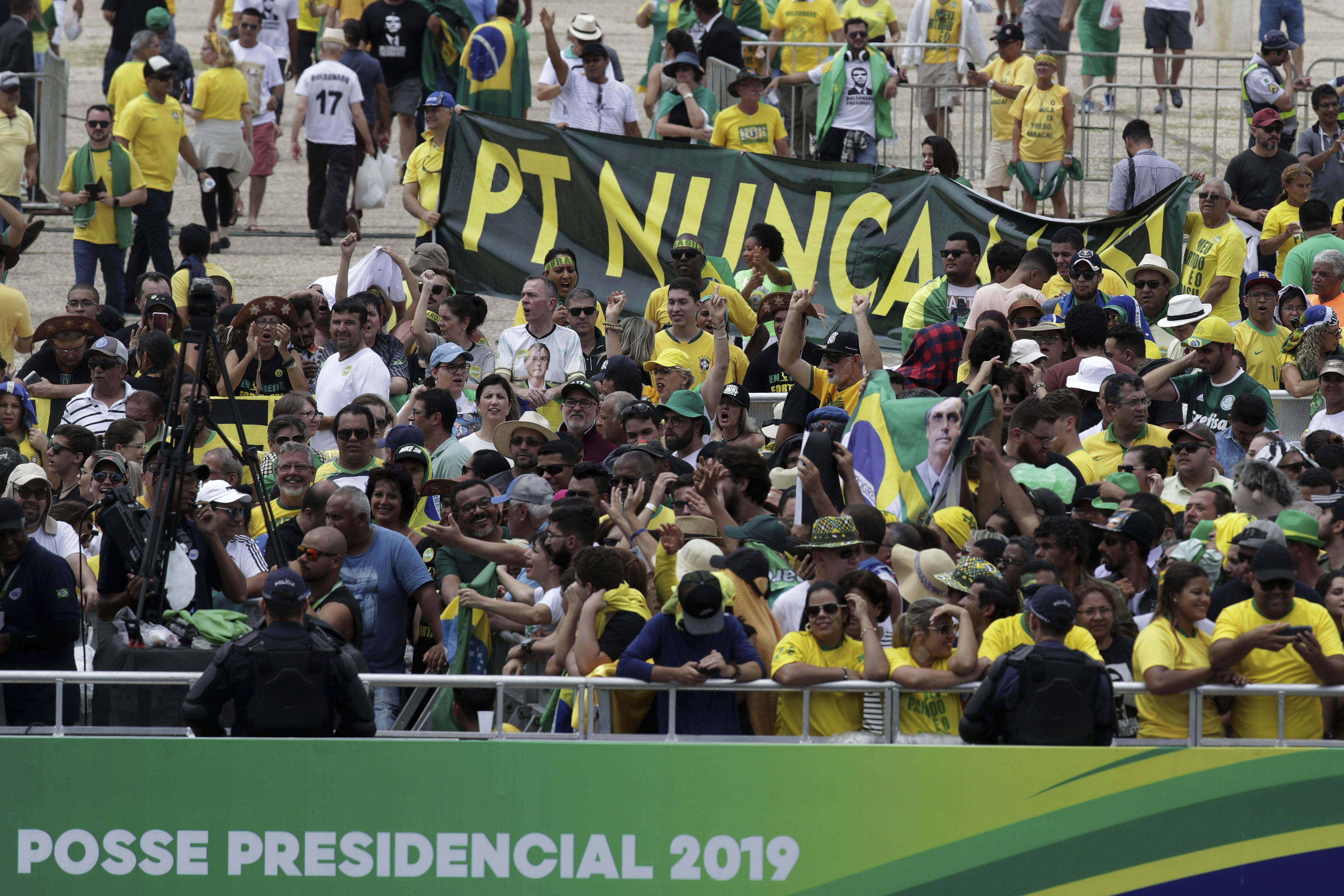 Supporters of Brazil's President Jair Bolsonaro hold a banner in the stands that reads in Portuguese 