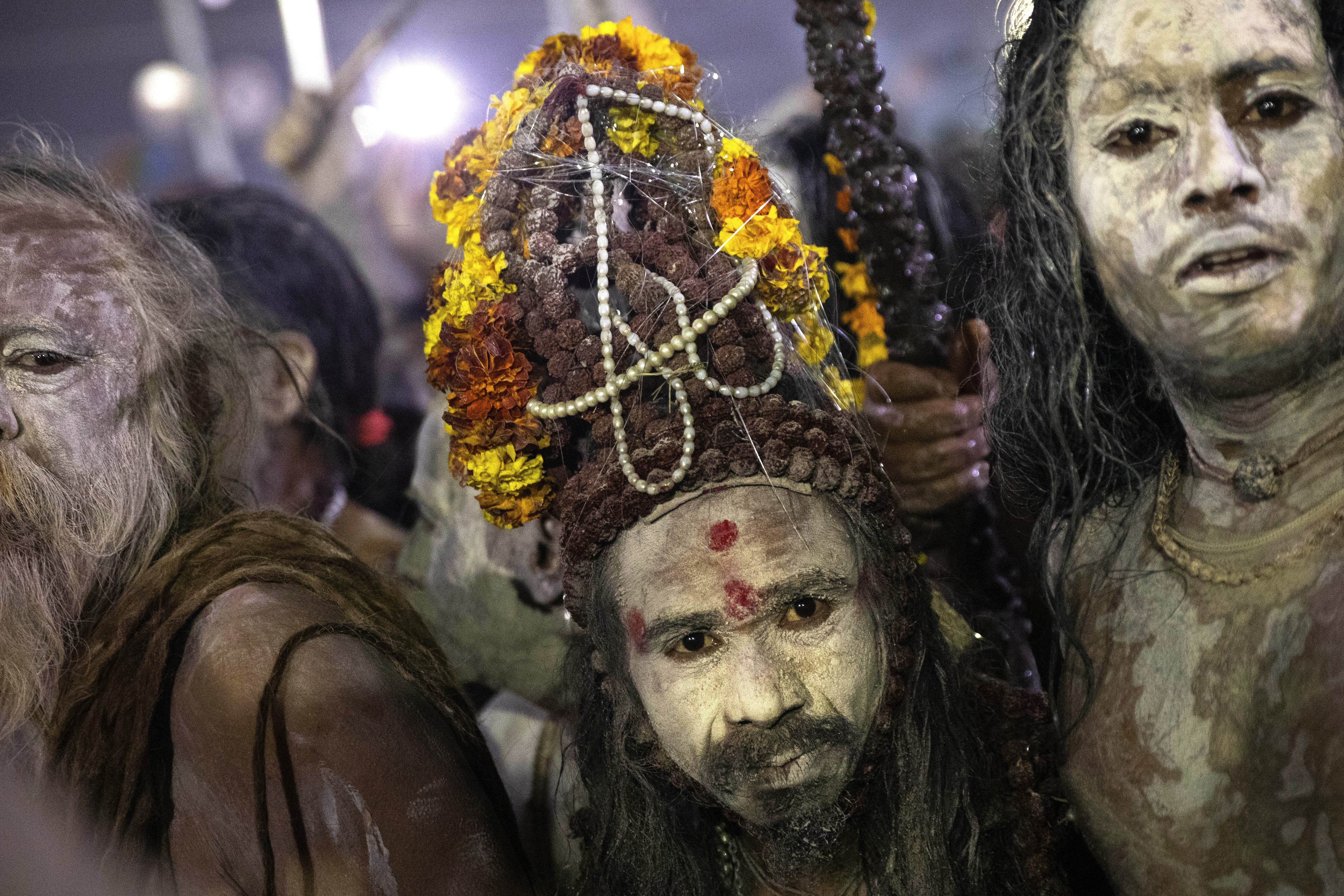 Indian Sadhus, or Hindu holy men, covered in ash walk before taking a ritualistic dip on auspicious Makar Sankranti day during the Kumbh Mela, or pitcher festival in Prayagraj, Uttar Pradesh state, India, Tuesday, Jan.15, 2019. The Kumbh Mela is a series of ritual baths by Hindu holy men, and other pilgrims at the confluence of three sacred rivers  the Yamuna, the Ganges and the mythical Saraswati  that dates back to at least medieval times. The city's Mughal-era name Allahabad was recently changed to Prayagraj. (AP Photo/Bernat Armangue)