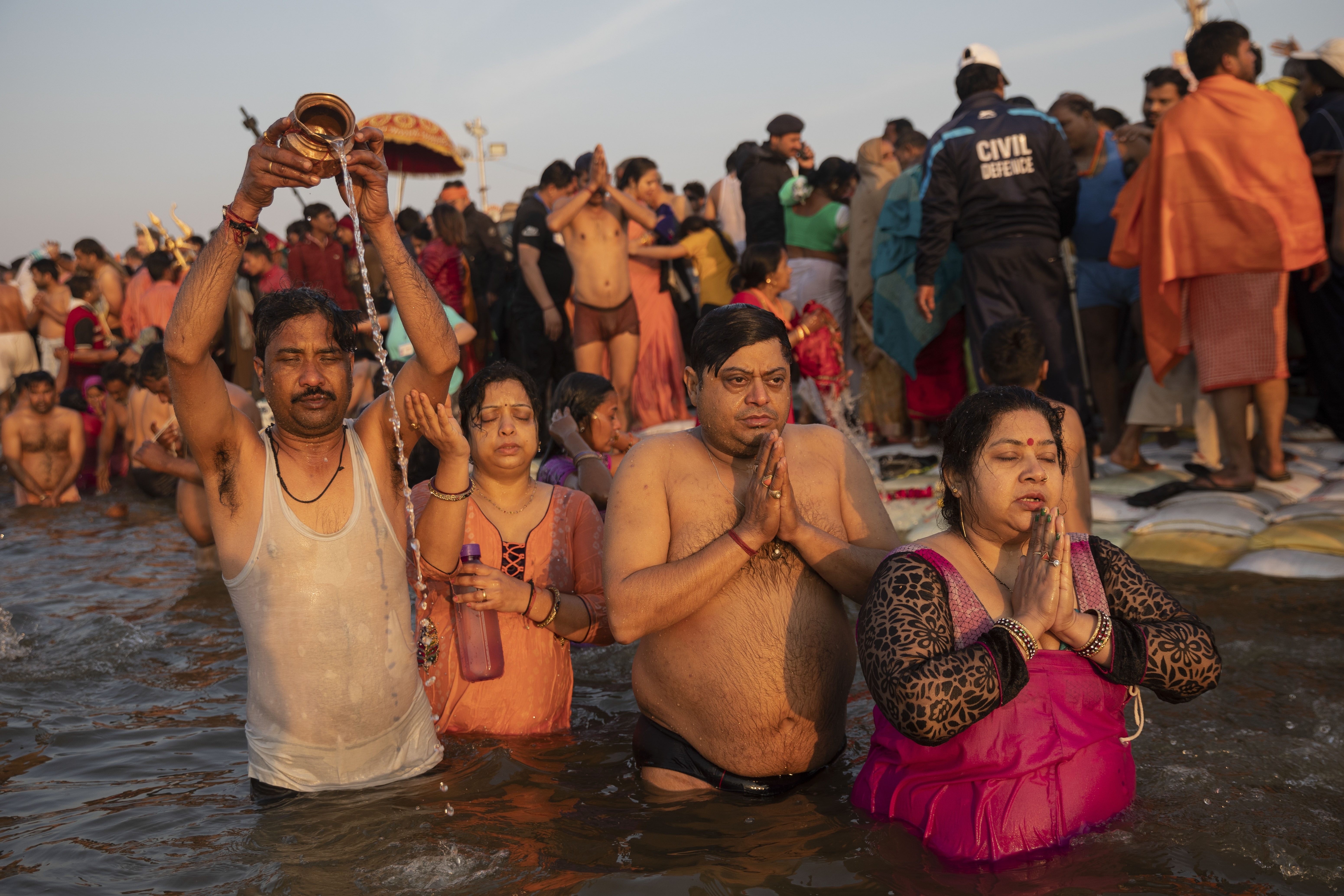 Hindu devotees take a dip on auspicious Makar Sankranti day during the Kumbh Mela, or pitcher festival in Prayagraj, Uttar Pradesh state, India, Tuesday, Jan.15, 2019. The Kumbh Mela is a series of ritual baths by Hindu holy men, and other pilgrims at the confluence of three sacred rivers the Yamuna, the Ganges and the mythical Saraswati that dates back to at least medieval times. The city's Mughal-era name Allahabad was recently changed to Prayagraj. (AP Photo/Bernat Armangue)