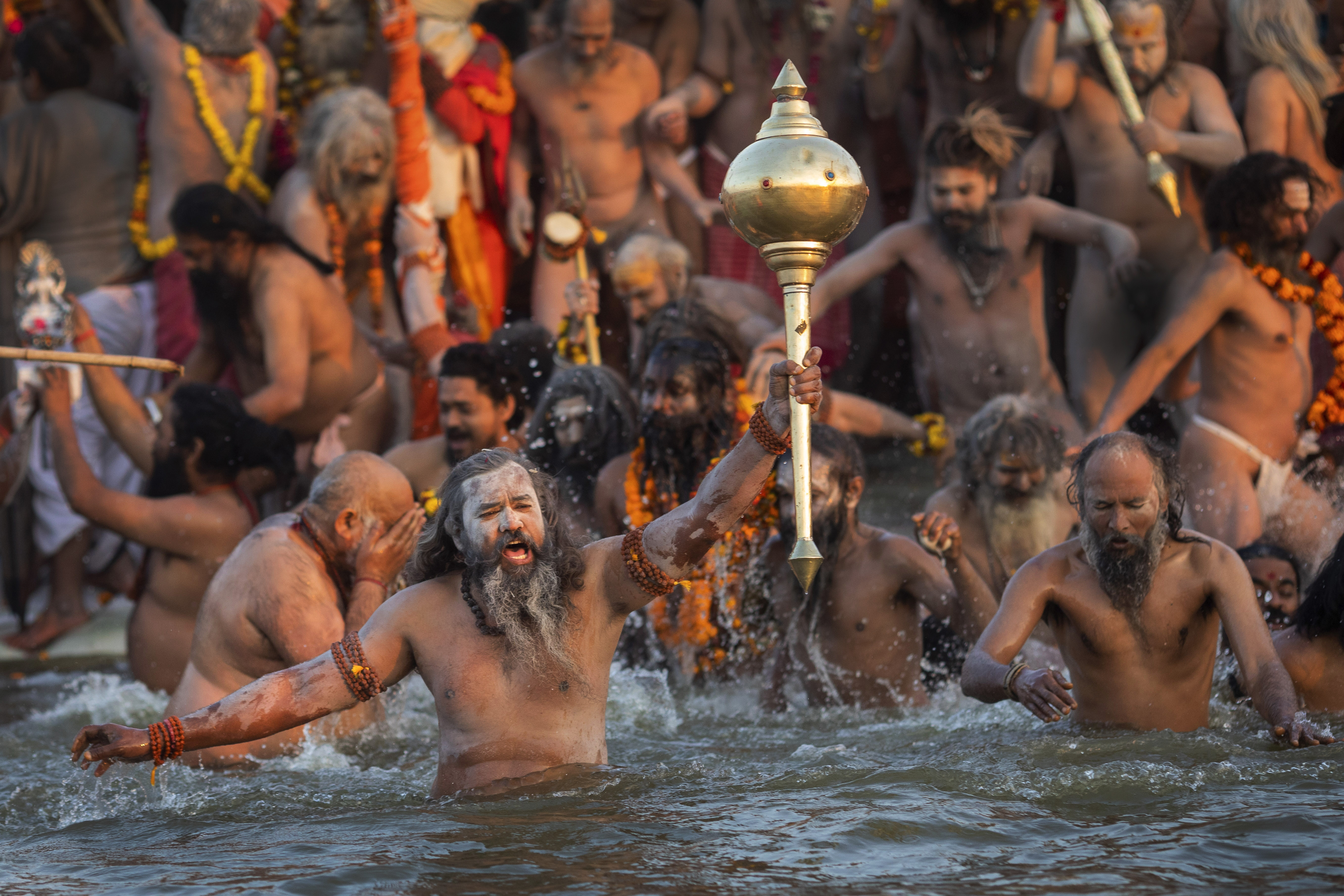 Hindu holy men take a dip on auspicious Makar Sankranti day during the Kumbh Mela, or pitcher festival in Prayagraj, Uttar Pradesh state, India, Tuesday, Jan.15, 2019. The Kumbh Mela is a series of ritual baths by Hindu holy men, and other pilgrims at the confluence of three sacred rivers the Yamuna, the Ganges and the mythical Saraswati that dates back to at least medieval times. The city's Mughal-era name Allahabad was recently changed to Prayagraj. (AP Photo/Bernat Armangue)
