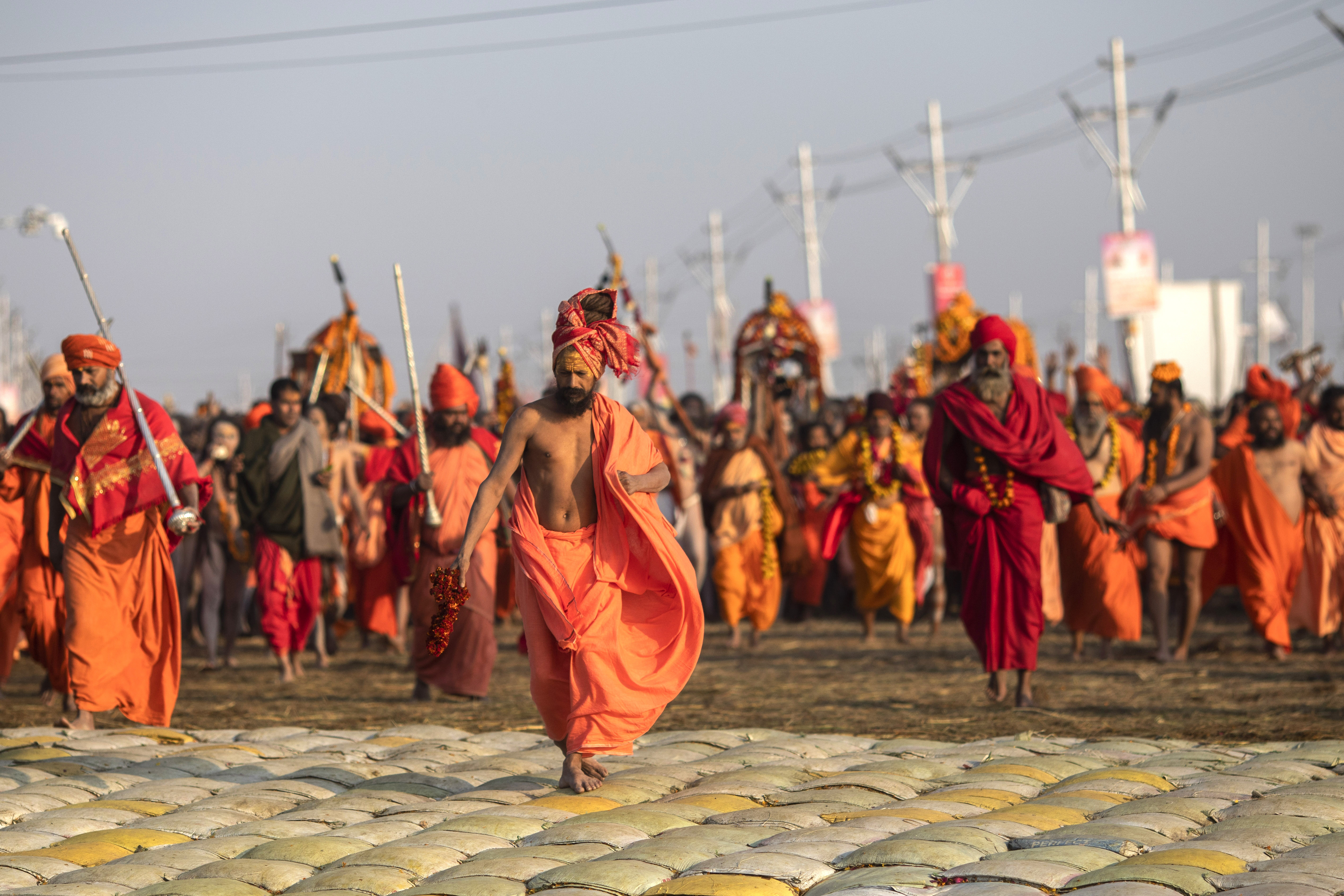 Hindu holy men arrive for ritualistic dip on auspicious Makar Sankranti day during the Kumbh Mela, or pitcher festival in Prayagraj, Uttar Pradesh state, India, Tuesday, Jan.15, 2019. The Kumbh Mela is a series of ritual baths by Hindu holy men, and other pilgrims at the confluence of three sacred rivers the Yamuna, the Ganges and the mythical Saraswati  that dates back to at least medieval times. The city's Mughal-era name Allahabad was recently changed to Prayagraj. (AP Photo/Bernat Armangue)