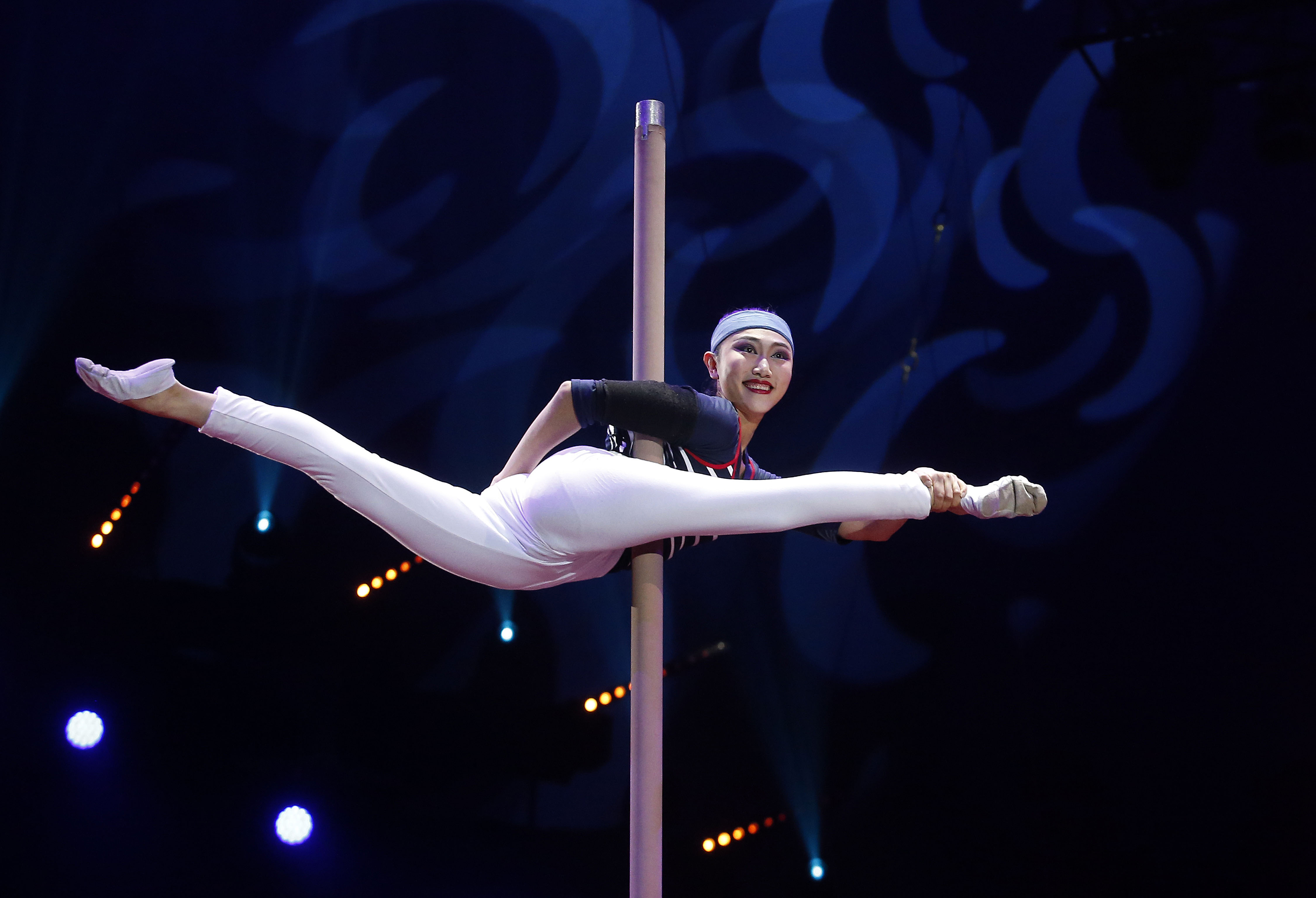 In this pool photo taken Thursday, Jan. 17, 2019, a member of the China National Acrobatic Troupe performs during the opening ceremony of the 43rd Monte-Carlo International Circus Festival in Monaco. The festival will run from Jan. 17 to 27. (Sebastien Nogier/Pool Photo via AP)